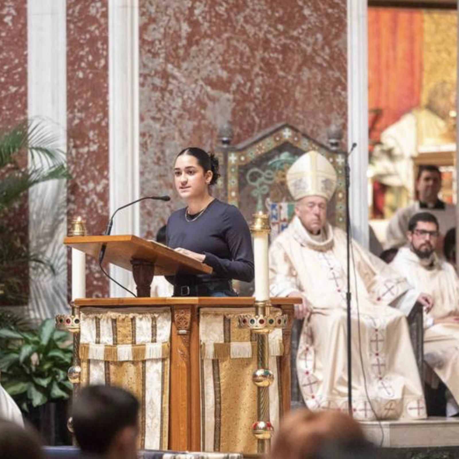 Andrea Patiño, a junior at the Academy of the Holy Cross in Kensington, Maryland, reads the first reading from the Book of Jeremiah during the Youth Mass for Life on Jan. 23, 2026 at the Cathedral of St. Matthew the Apostle in Washington, D.C. At left is Msgr. W. Ronald Jameson, the cathedral’s rector. Before the Mass, she offered a testimony on how she came to understand the dignity and value of human life. (Catholic Standard photo by Mihoko Owada)