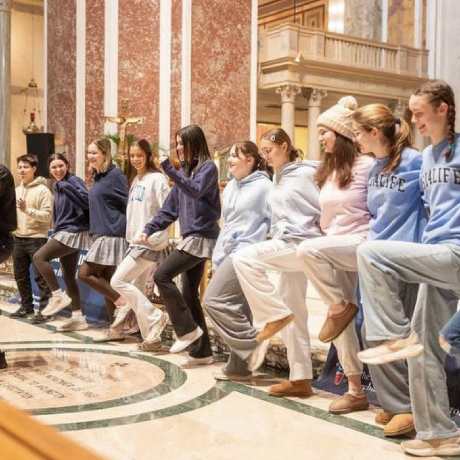 Before the Youth Mass for Life on Jan. 23 at St. Matthew's Cathedral, Father John Benson - the pastor of St. John Vianney Parish in Prince Frederick, Maryland - sang while youth formed a dance line behind him during a rally. (Catholic Standard photo by Mihoko Owada)