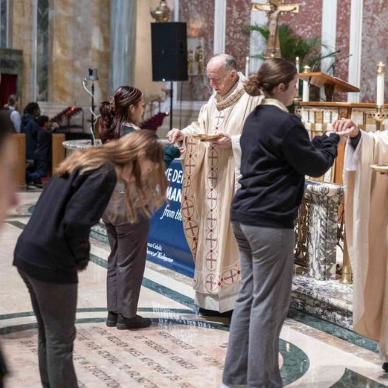 Washington Cardinal Robert W. McElroy and Auxiliary Bishop Roy Campbell Jr. give Communion to young people during the Youth Mass for Life on Jan. 23, 2026 at St. Matthew's Cathedral. (Catholic Standard photo by Mihoko Owada)