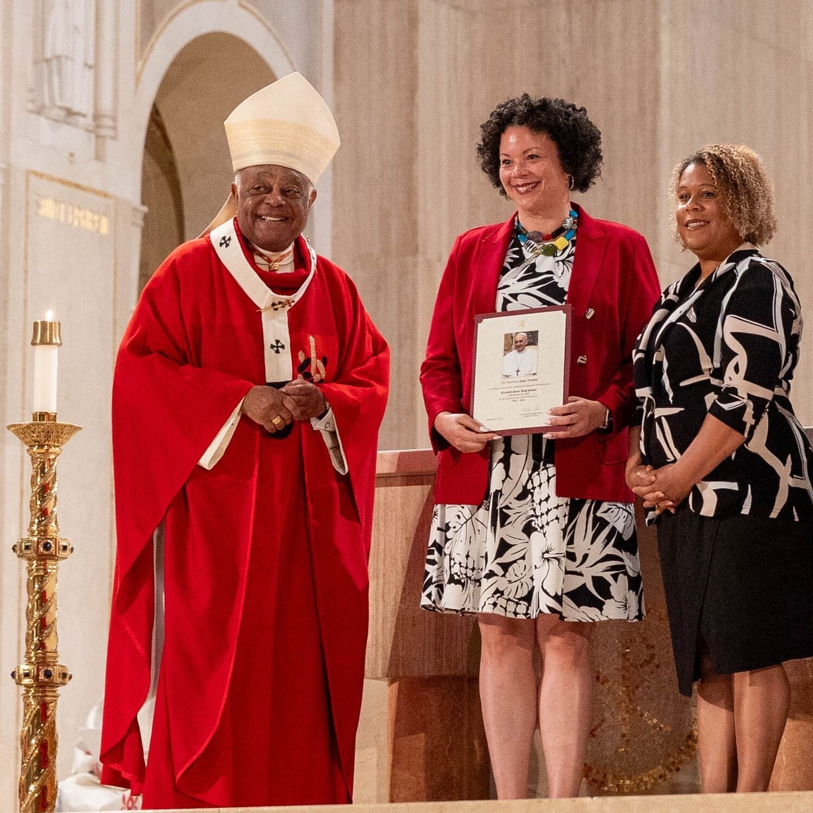 At the Opening of Schools Mass on Aug. 26 at the National Shrine, the local Catholic schools celebrating milestone anniversaries this year included Elizabeth Seton High School in Bladensburg, Maryland, which is marking its 65th anniversary. From left to right are Cardinal Wilton Gregory; Dr. Lisa Grillo, the president of Elizabeth Seton High School;  Erica Boursiquot, the director of advancement at Elizabeth Seton; and Kelly Branaman, the Secretary for Catholic Schools and Superintendent of Schools for The Roman Catholic Archdiocese of Washington. (Catholic Standard photo by Mihoko Owada)