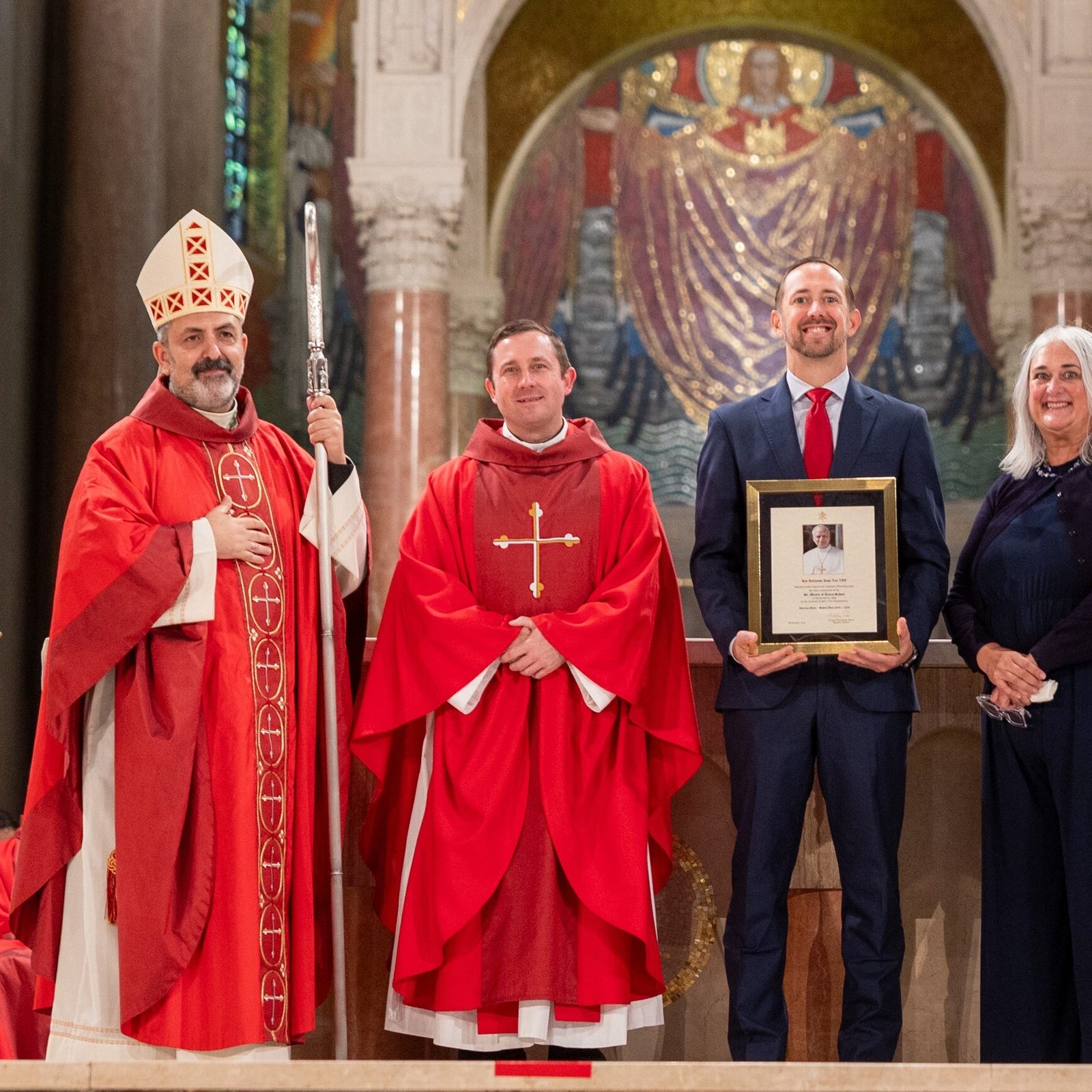 At the Opening of Schools Mass for the Roman Catholic Archdiocese of Washington on Aug. 25, 2025 at the Basilica of the National Shrine of the Immaculate Conception, the schools honored for milestone anniversaries included St. Martin of Tours School in Gaithersburg, Maryland, which is marking its 100th anniversary this school year. From left to right are Washington Auxiliary Bishop Juan Esposito, the main celebrant at the Mass; Father David Wells, the pastor of St. Martin of Tours Parish; Stephen Lamont, the principal of St. Martin of Tours School; and Kelly Branaman, the archdiocese’s Secretary for Catholic Schools and Superintendent of Schools. (Catholic Standard photo by Mihoko Owada)