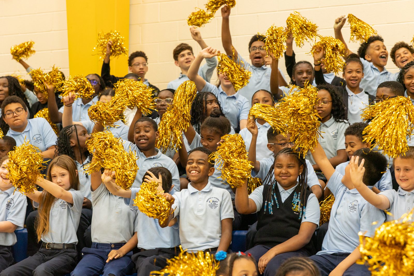 Students at St. Mary of the Assumption Catholic School in Upper Marlboro, Maryland, cheer and wave pom-poms during a surprise assembly in the school gym on April 15, where it was announced that Renee Clark, the resource teacher there, is a 2024 Golden Apple Award-winning teacher. (Catholic Standard photo by Mihoko Owada)