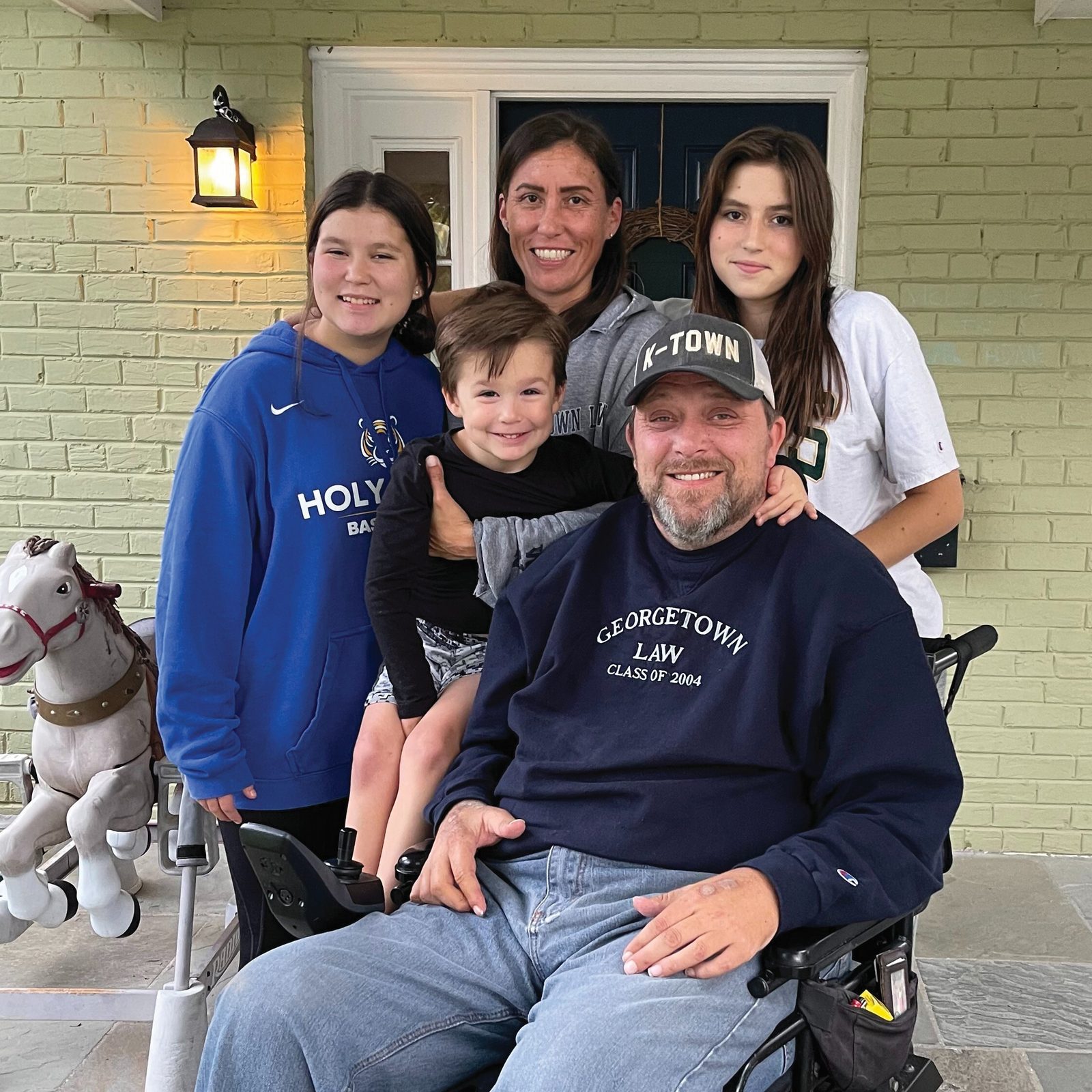 Tim Strachan and his wife Leslie are shown in a photo with their three children, (from left to right) Sophie, Luke and Olivia. Tim Strachan – a star quarterback at DeMatha Catholic High School in Hyattsville who was paralyzed in a swimming accident in 1993 – graduated with honors at DeMatha the next year and went on to earn a communications degree at the University of Maryland and a law degree from Georgetown University. He served as an attorney for the federal government, was a radio broadcaster for University of Maryland football games and was a well-known motivational speaker in the Washington area. Tim Strachan died on July 8 at the age of 49 after suffering from cancer. A gofundme page has been set up to support his family. (Screengrab photo from https://www.gofundme.com/f/t13-fund-honoring-the-legacy-of-tim-strachan)