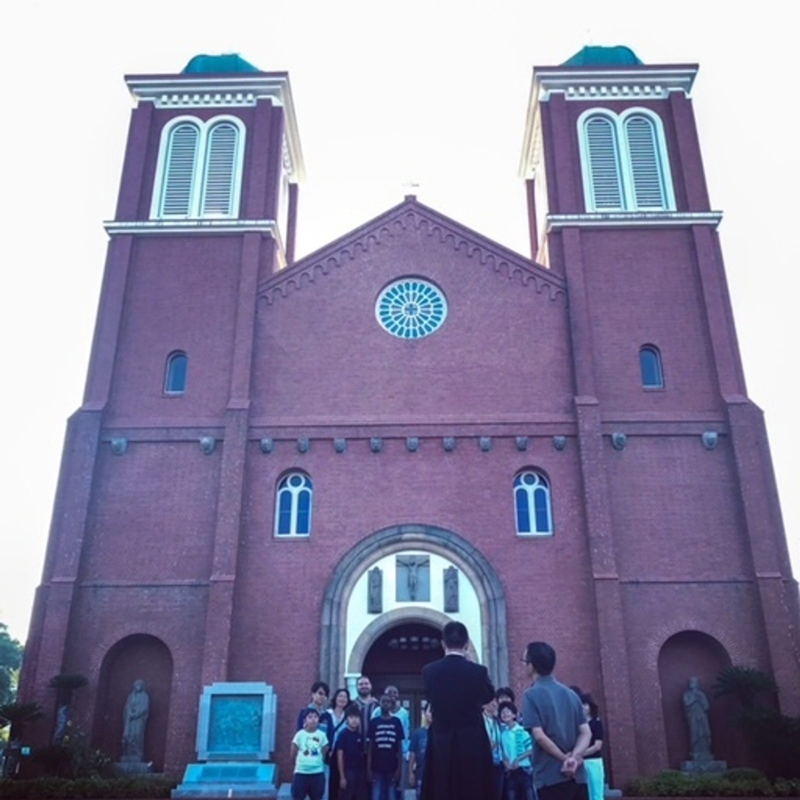 In a photo taken in 2017, a priest takes a photo of a pilgrimage group from northern Japan visiting Urakami Cathedral in Nagasaki, Japan. The present-day Urakami Cathedral was rebuilt in 1959 in the style of the cathedral there that was destroyed by the atomic bomb dropped on that city on Aug. 9, 1945. (Catholic Standard photo by Mihoko Owada)