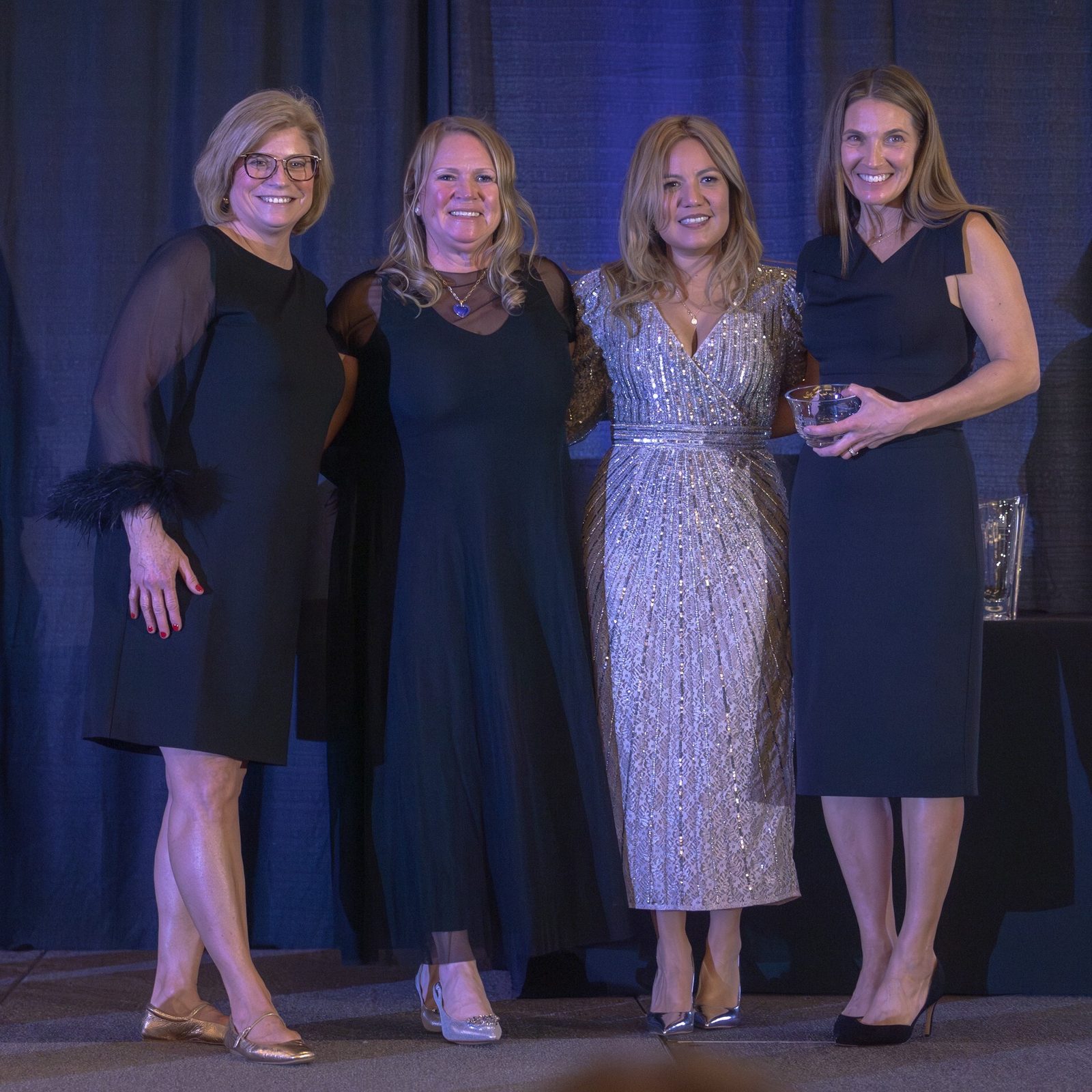 Katie May at right from Holy Redeemer Catholic School in Kensington, Maryland, received the Catholic School Volunteer of the Year Award at the Catholic Business Network of Montgomery County’s Gala on Nov. 22, 2024 at the Bethesda North Marriott Hotel & Conference Center. From left to right are Jeanne Donatelli, the principal of St. Jude Regional Catholic School in Rockville who announced the award; Susan Apgood, the emcee for the gala; Greta Vento, the president of CBN-MC; and Katie May, the Catholic School Volunteer of the Year Award recipient. (Catholic Standard photo by Mihoko Owada)