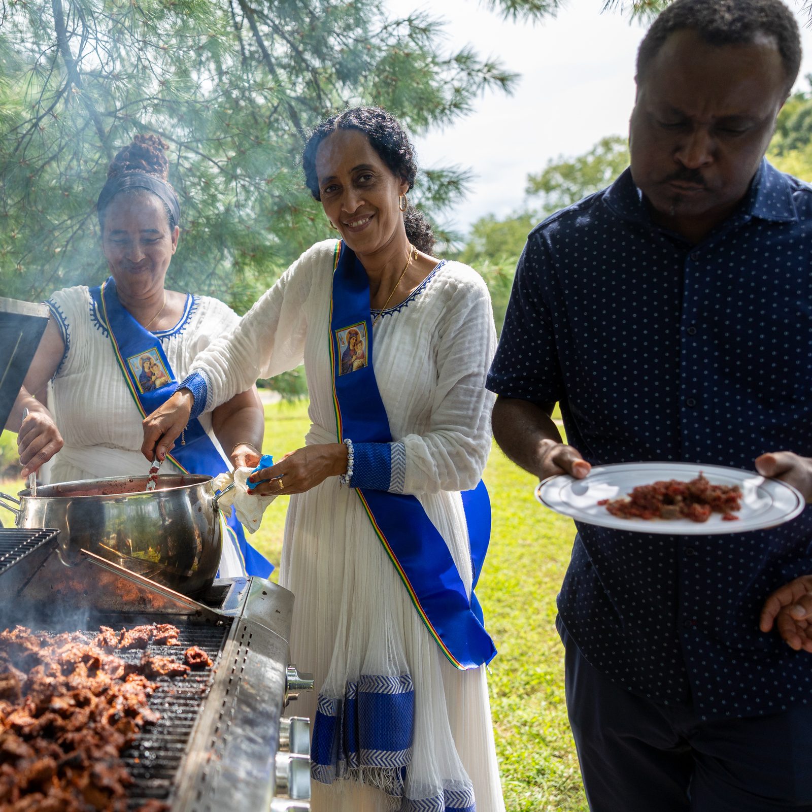 Volunteers prepare and serve traditional food at a lunch for members and guests of the Kidane-Mehret Parish for Ethiopian Catholics after a Mass on Aug. 24, 2025 at Holy Spirit Church in Forestville, Maryland. The Mass marked Holy Spirit Church being the new home for that community. (Catholic Standard photo by Mihoko Owada)