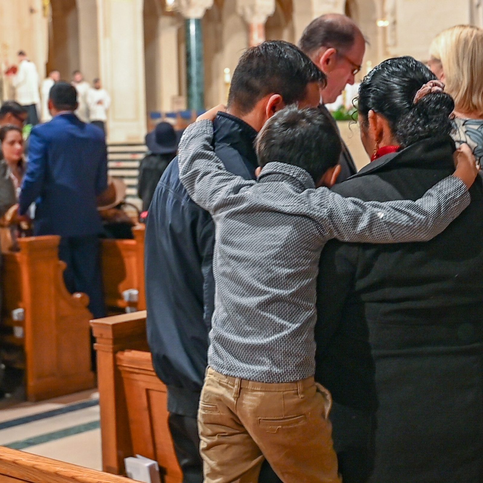 A boy embraces his father and mother as couples renew their vows during the Annual Wedding Mass of the Archdiocese of Washington on Feb. 8, 2025 to celebrate the vocation of marriage at the Basilica of the National Shrine of the Immaculate Conception. (Catholic Standard photos by Nicole Olea)