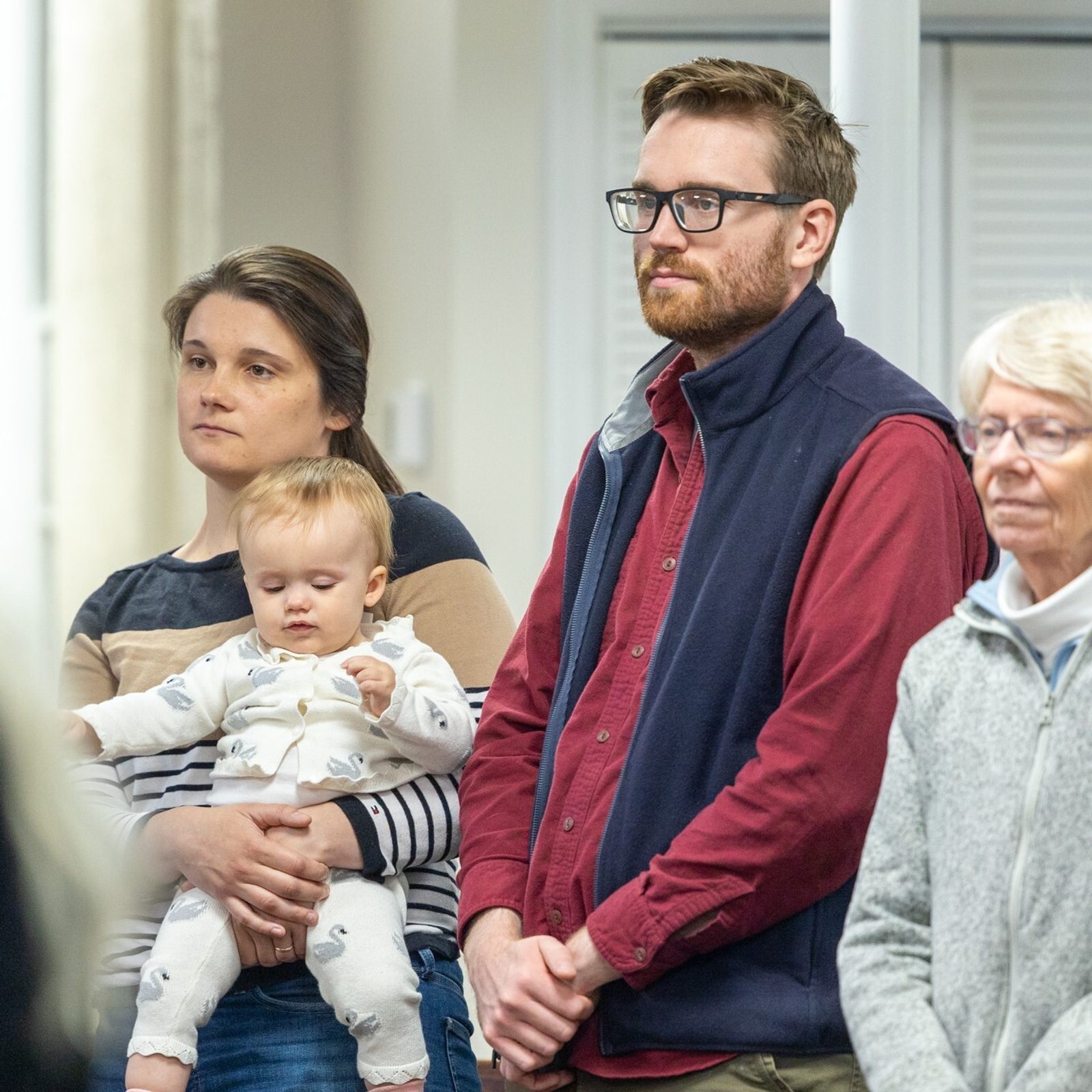 Kathryn Yanik, the director of the Office of Life Issues of The Roman Catholic Archdiocese of Washington, holds her baby daughter Clare and is joined by her husband Robert Yanik and her mother-in-law Marianne Yanik at a May 11 Mass at the Pope Francis Center in Landover Hills for people living with mental health challenges. (Catholic Standard photo by Mihoko Owada)