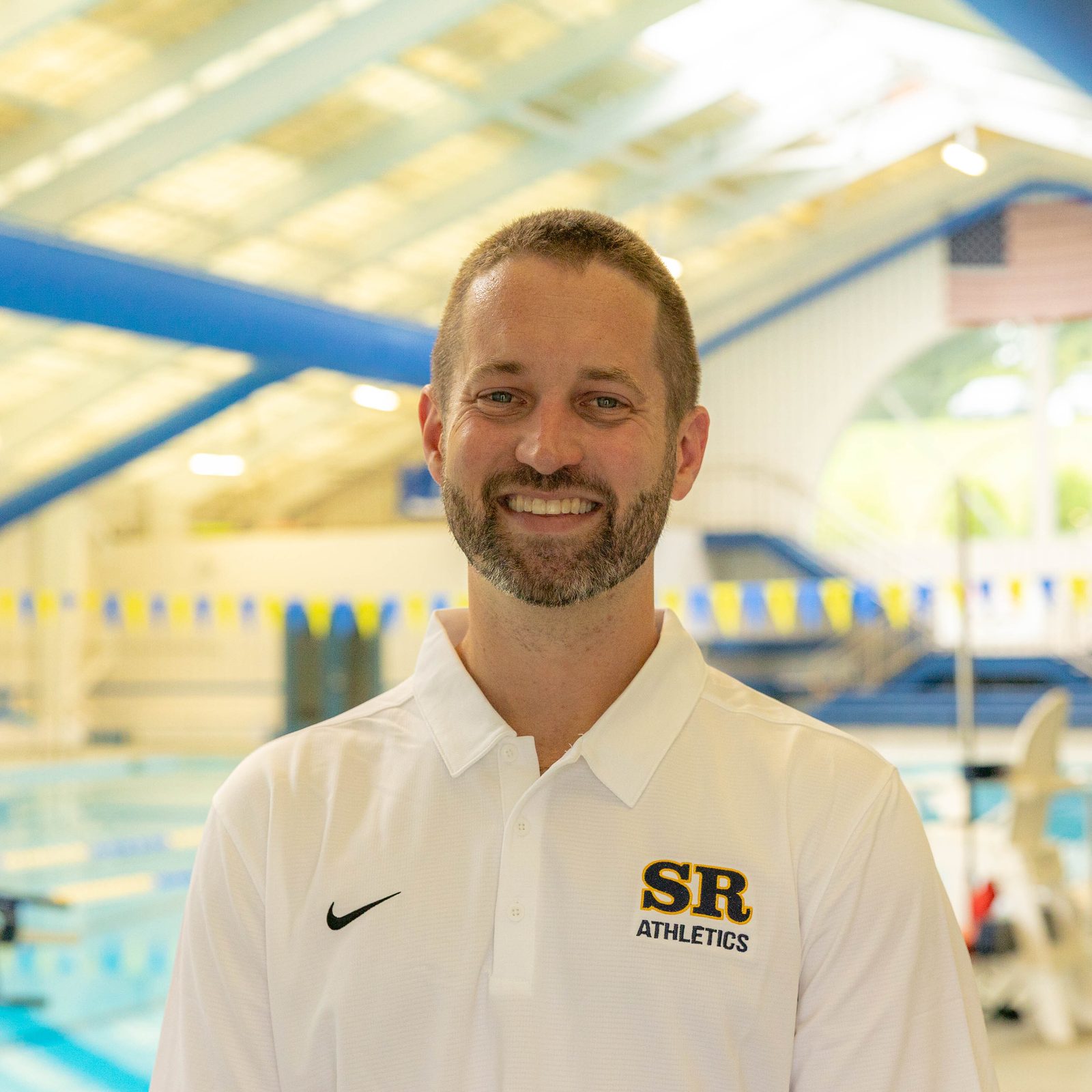 Andrew Maguire, the director of athletics at Stone Ridge School of the Sacred Heart in Bethesda, stands at the Aquatic Center before a July 25 pep rally at Stone Ridge School of the Sacred Heart in Bethesda celebrating three of the school’s graduates – Katie Ledecky (class of 2015), Phoebe Bacon (class of 2020) and Erin Gemmell (class of 2023) – who are members of the U.S. Olympic Swimming Team competing in the Summer Olympics in Paris. (Catholic Standard photo by Mihoko Owada)