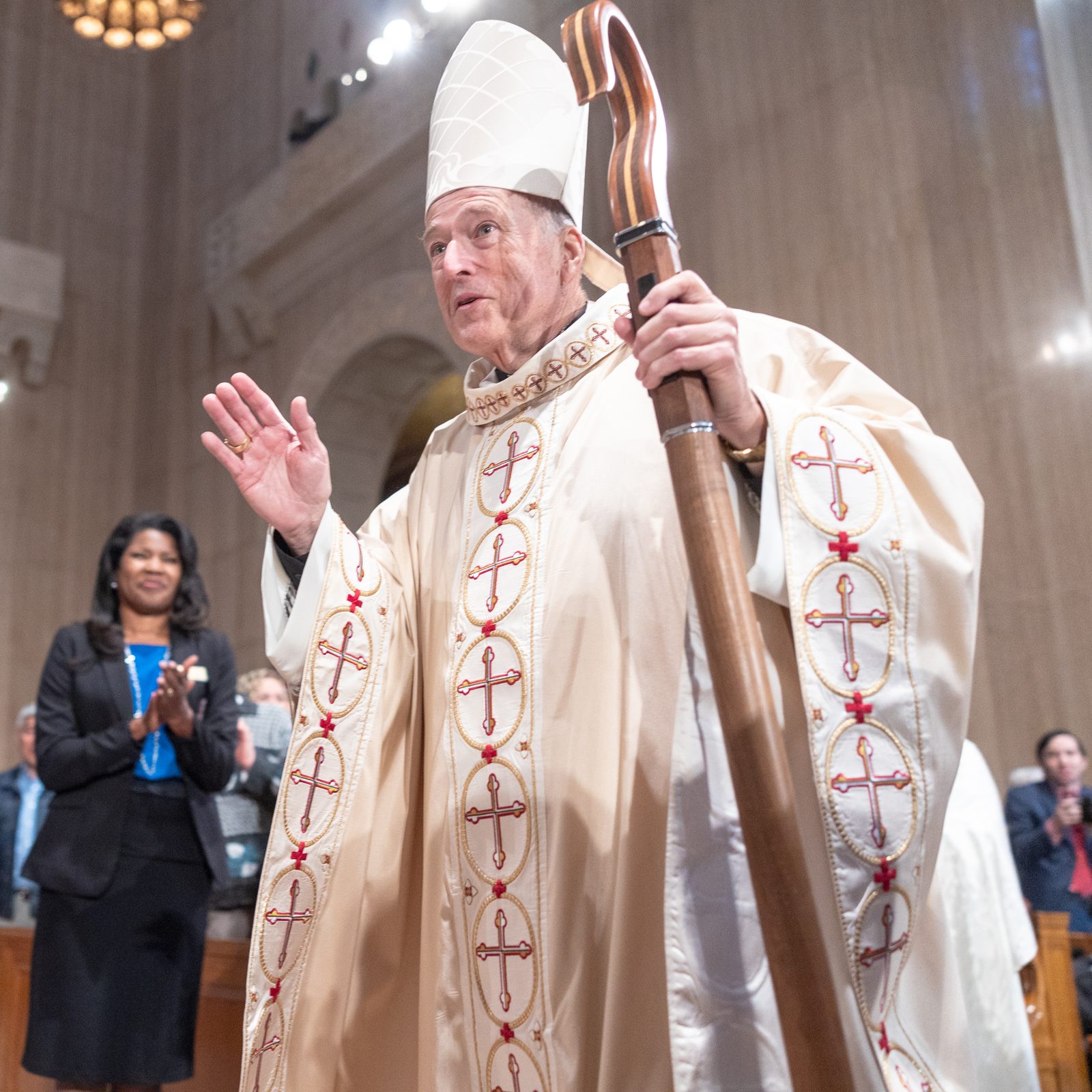 Cardinal Robert McElroy blesses the faithful at the Basilica of the National Shrine of the Immaculate Conception as he processes from the altar following his Solemn Mass of Installation on March 11, 2025 as the new archbishop of Washington. Among those applauding at center is Paula Gwynn Grant, the secretary for communications for The Roman Catholic Archdiocese of Washington. (Catholic Standard photo by Mihoko Owada)