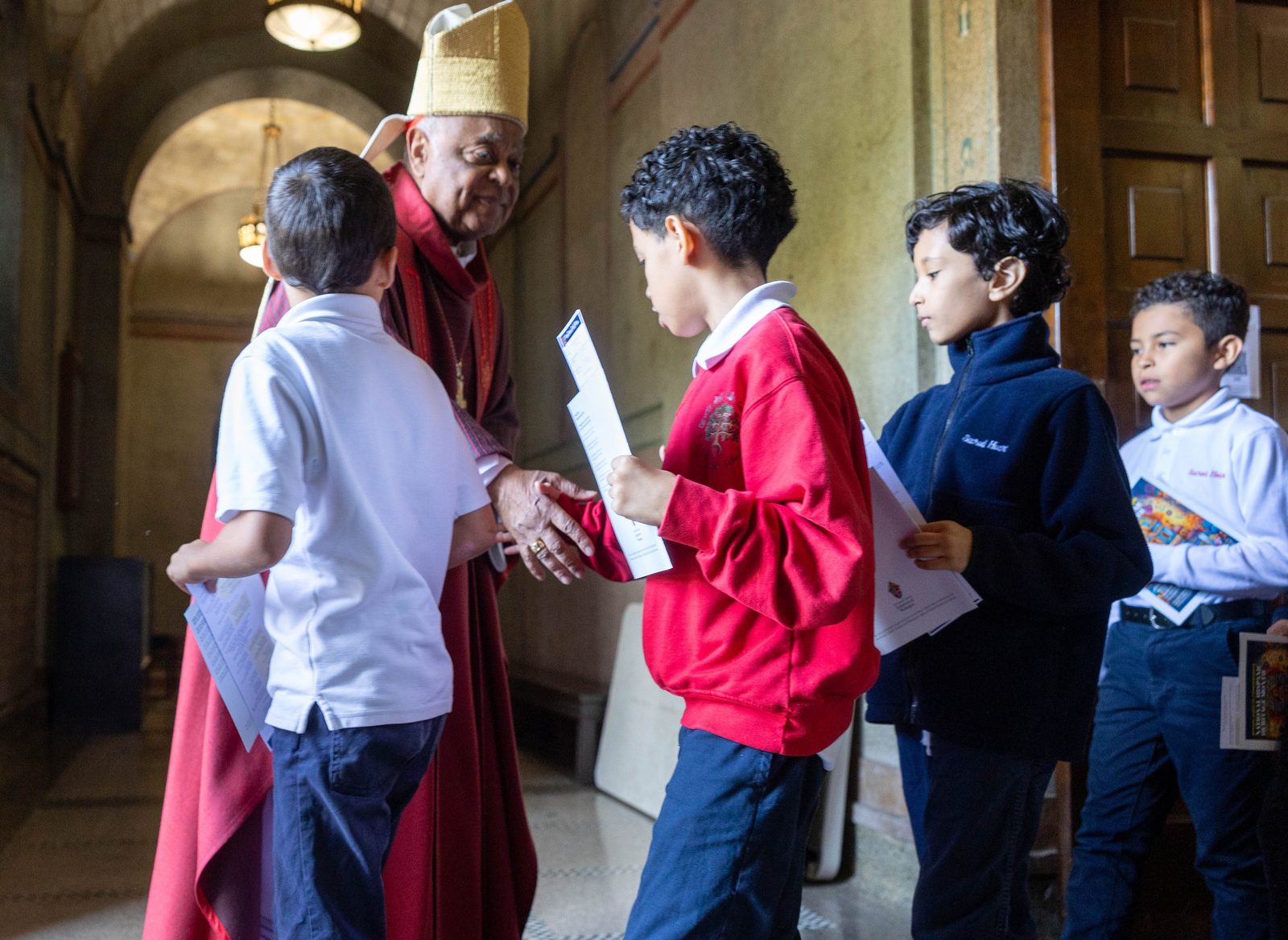 Cardinal Wilton Gregory greets students from Sacred Heart School after celebrating a Sept. 20 Mass at the Shrine of the Sacred Heart in Washington marking National Hispanic Heritage Month. (Catholic Standard photos by Mihoko Owada)