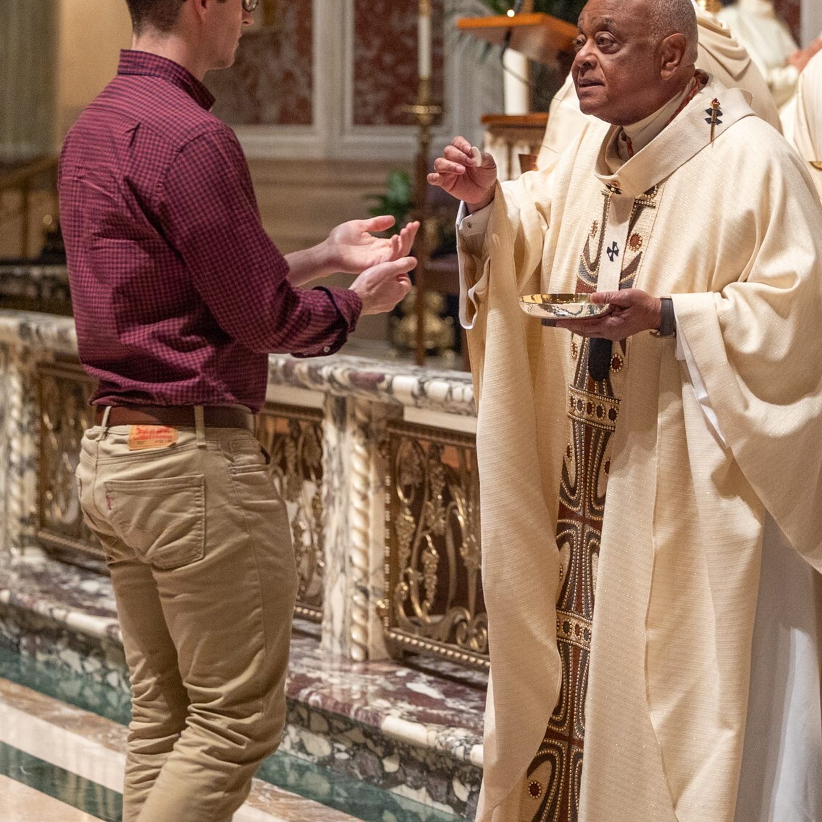 Cardinal Wilton Gregory gives Communion to a man during the Mass of the Lord’s Supper on Holy Thursday, March 28, at the Cathedral of St. Matthew the Apostle in Washington, D.C. (Catholic Standard photo by Mihoko Owada)