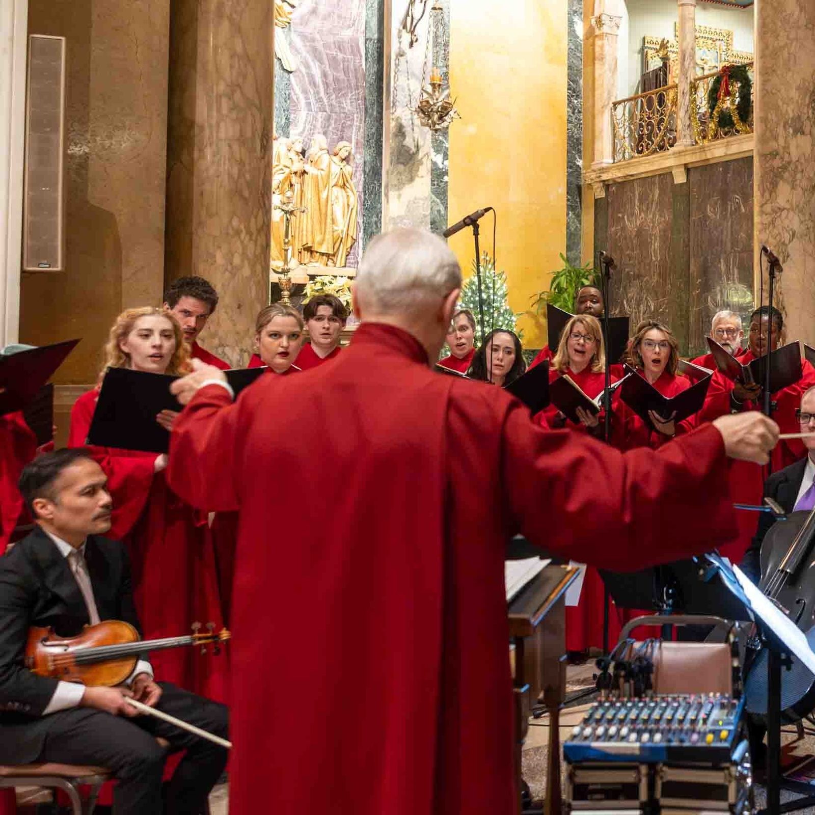 Thomas Stehle leads members of the Schola Cantorum choir at the Cathedral of St. Matthew the Apostle in Washington as they sing before a Vigil Mass for the Solemnity of the Nativity of the Lord celebrated by Cardinal Robert W. McElroy on Christmas Eve, Dec. 24, 2025. Stehle serves as the cathedral’s pastoral associate for liturgy and director of music ministries. (Catholic Standard photo by Mihoko Owada)