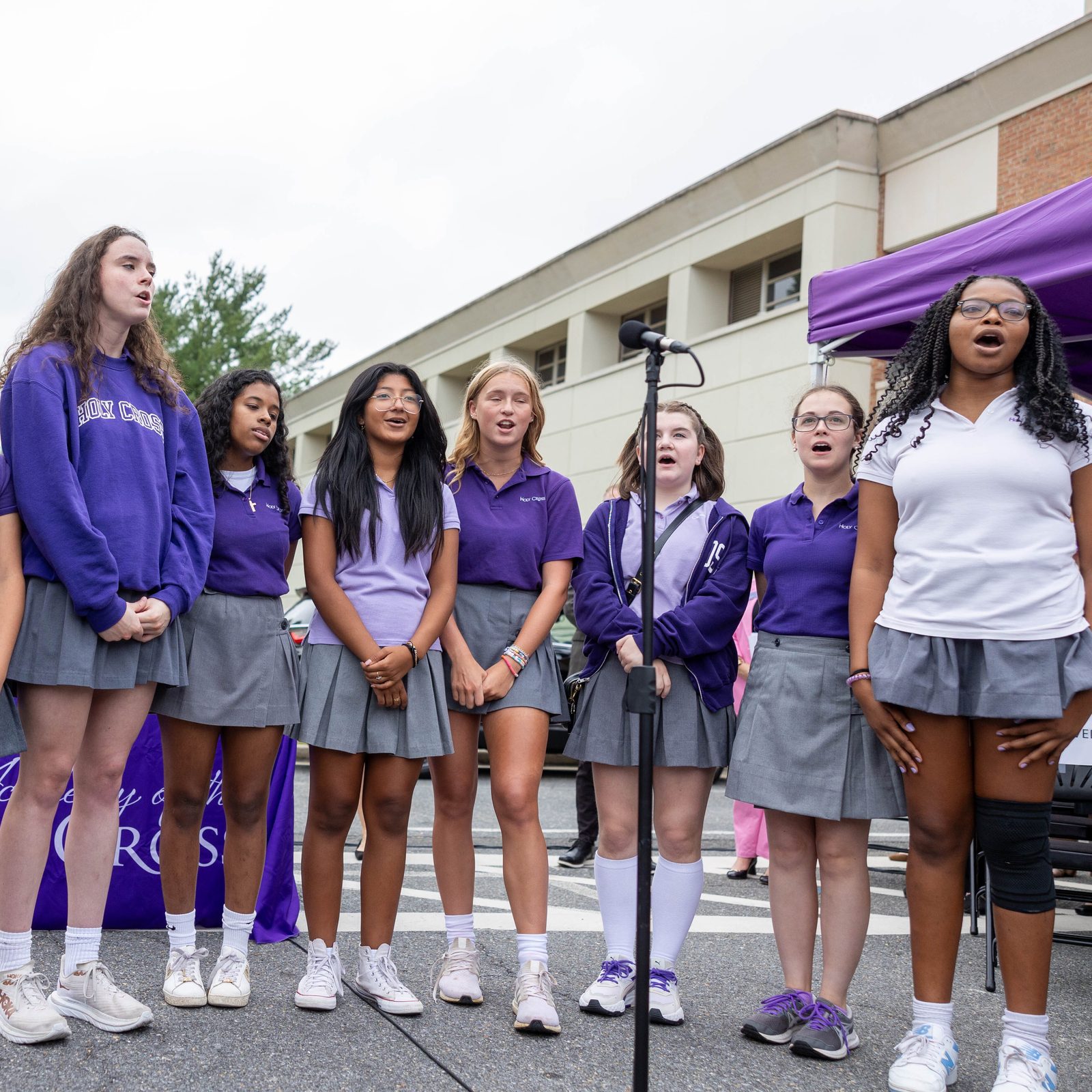 The Madrigal Singers at The Academy of the Holy Cross in Kensington, Maryland, sing their school’s Alma Mater during a ground blessing ceremony for the new Athletic and Wellness Center there on Sept. 13, 2024. Washington Cardinal Wilton Gregory said prayers and sprinkled holy water to bless the site where the new Athletic and Wellness Center will be built on the campus. (Catholic Standard photo by Mihoko Owada)