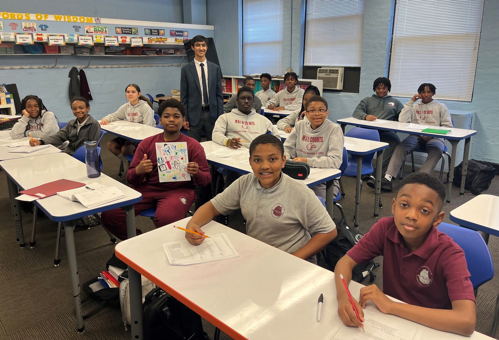 In a photo from May 2024, Zayd Patel, now a senior at The Heights School in Potomac, Maryland, poses for a photo with middle school students at St. Francis Xavier Catholic Academy in Washington, D.C., after teaching them math in an after-school program. Patel is now in his third year of doing that volunteer work there. (Catholic Standard photo by Mark Zimmermann)