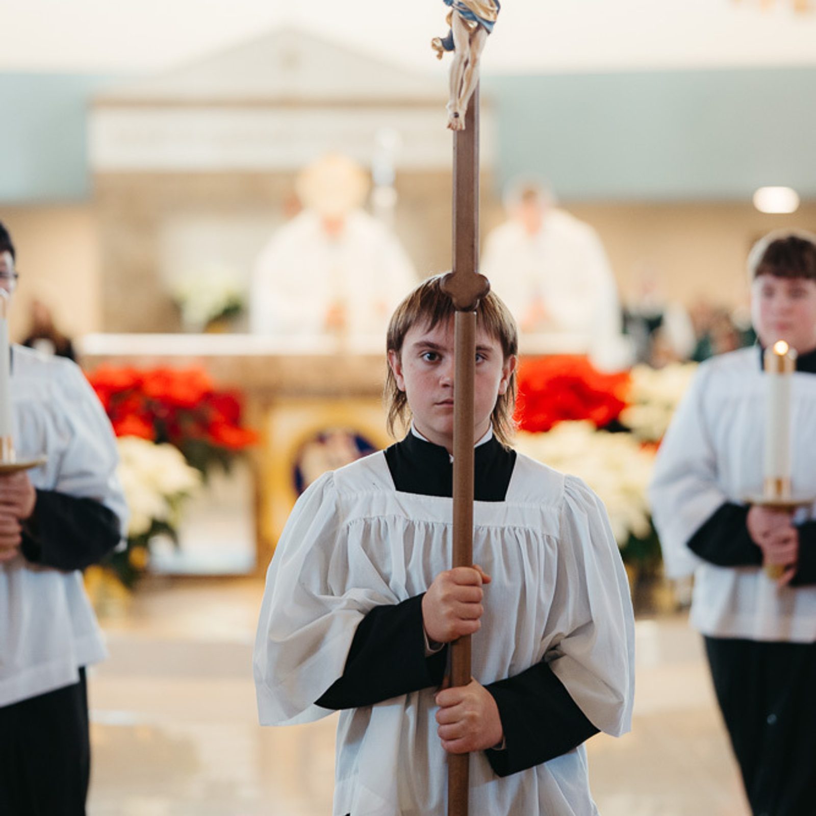 Altar server Kyle Van Ryswick, an eighth grader from St. Michael’s School in Ridge, Maryland, serves as the cross bearer in the closing procession of a Catholic Schools Week Mass for St. Mary’s County Catholic schools on Jan. 22, 2026 at Immaculate Heart of Mary Church in Lexington Park, Maryland. (Catholic Standard photo by Nicole Olea)