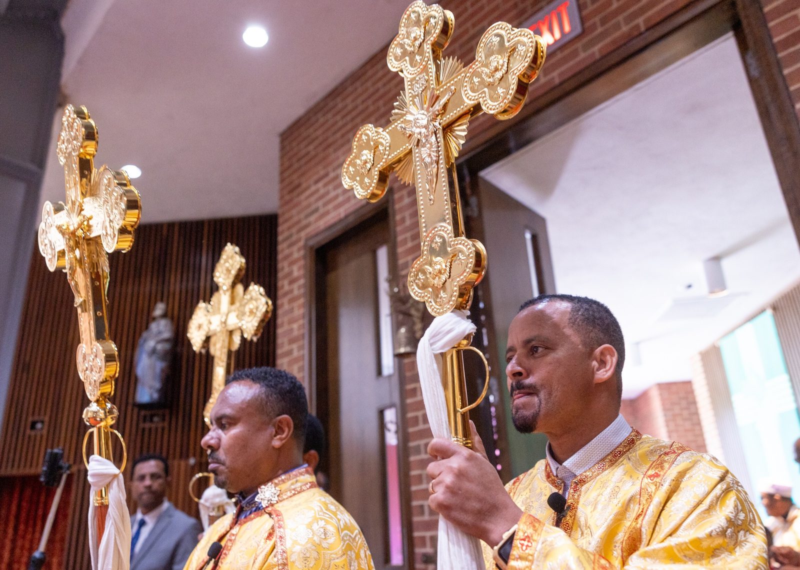 Cross bearers prepare to join the opening procession for a Mass on Aug. 24, 2025 at Holy Spirit Church in Forestville, Maryland, for the Kidane-Mehret Parish for Ethiopian Catholics in The Roman Catholic Archdiocese of Washington. The Mass marked the feast day of the Assumption of the Blessed Virgin Mary and also marked Holy Spirit Church being the new home for that community. (Catholic Standard photo by Mihoko Owada)