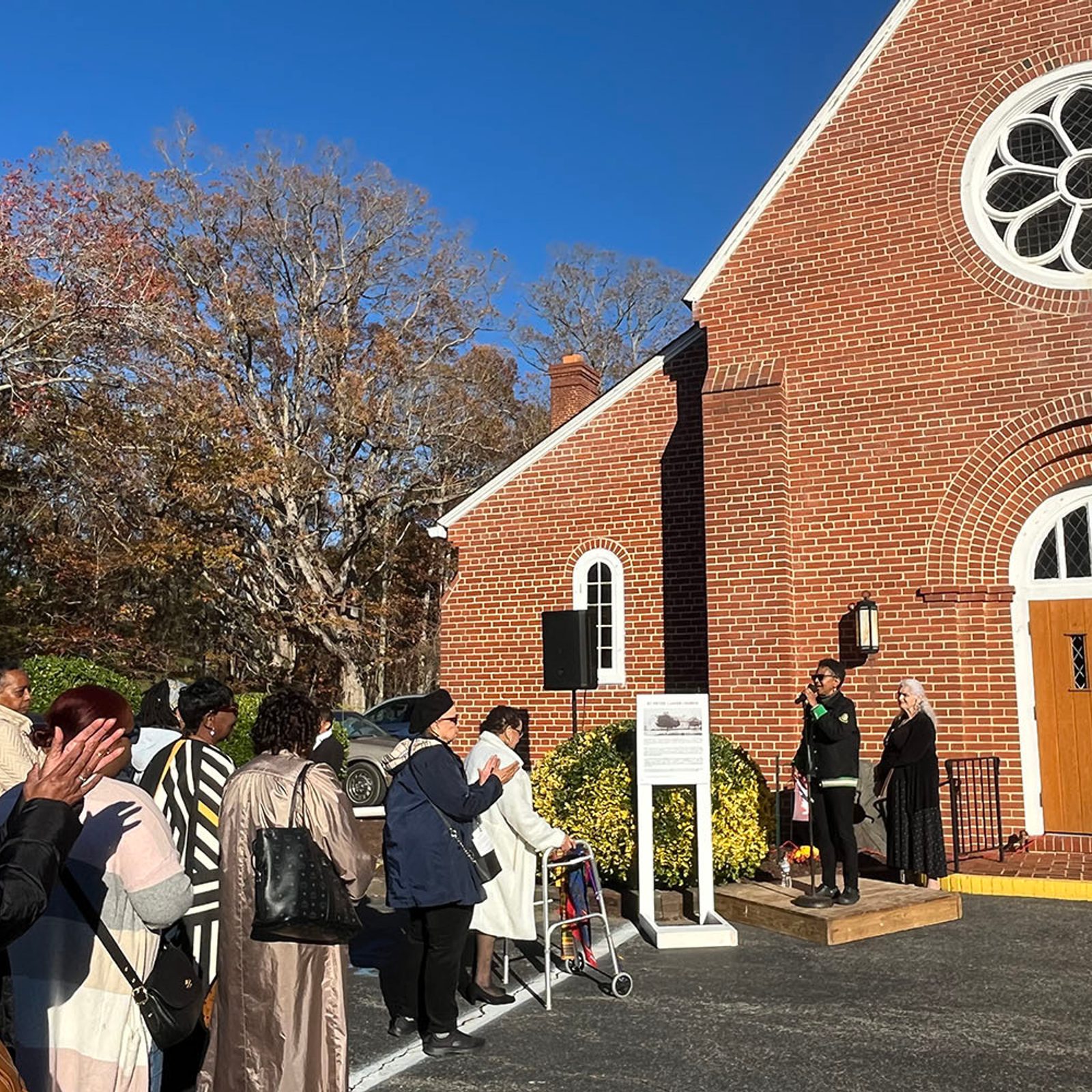 During a pilgrimage to Black Catholic roots in Southern Maryland on Nov. 16, 2024 to commemorate Black Catholic History Month, Dr. Francine Hawkins speaks in front of St. Peter Claver Church in St. Inigoes, Maryland. St. Peter Claver Parish – the only predominantly African American Catholic parish in St. Mary’s County – hosted the pilgrimage and Mass that were sponsored by the Office of Cultural Diversity and Outreach of The Roman Catholic Archdiocese of Washington. St. Peter Claver Church, the second church there, was completed in 1938 and designed by architect Philip Frohman, who also designed the National Cathedral in Washington, D.C. (Catholic Standard photo by Mark Zimmermann)