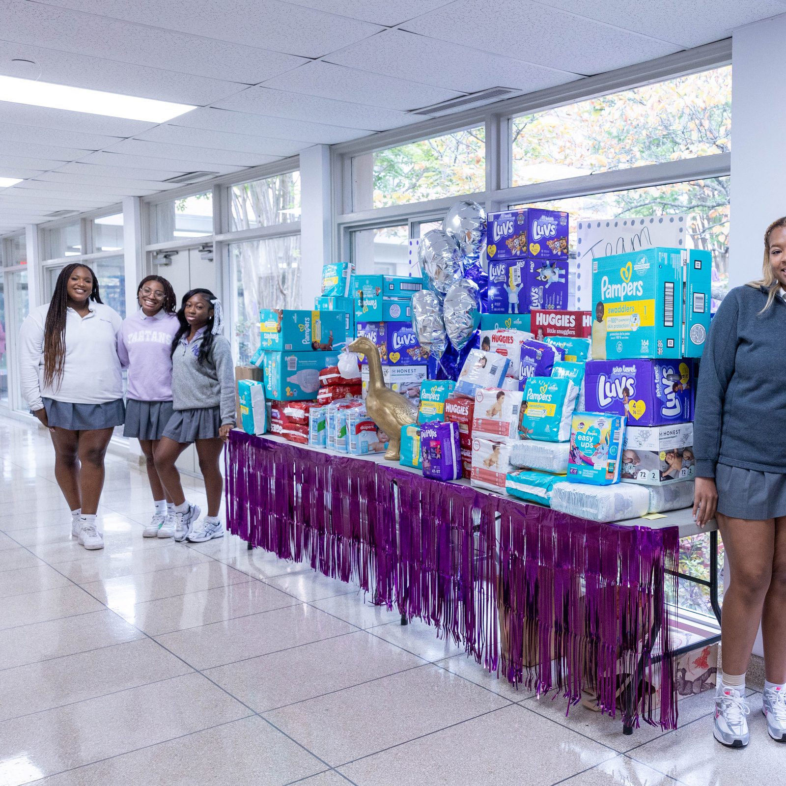 Students at The Academy of the Holy Cross in Kensington, Maryland, held a diaper drive and collected 5,000 diapers at the start of the new school year to benefit mothers and children helped by the Greater DC Diaper Bank. Standing beside some of the collected diapers at the school at left are seniors Emmah Reese and Gabby Hill and sophomore Chisimdi Iweanoge, and standing at right are senior Isabella Thompson, sophomore Kate Bickel and junior Addison Ruszkowski. (Catholic Standard photo by Mihoko Owada)