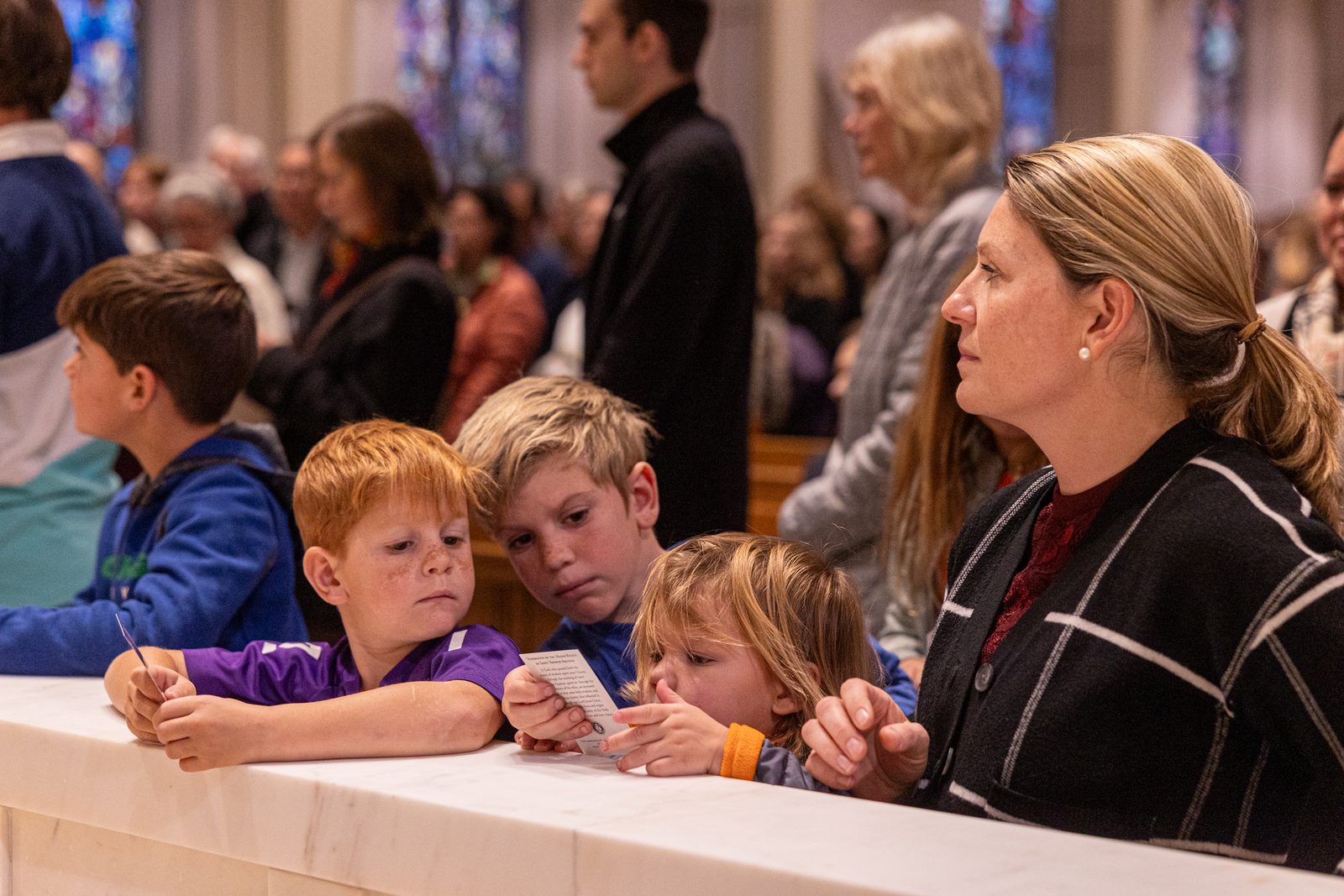 Family members attend a Mass on Nov. 29, 2024 at St. Dominic Church in Washington, D.C., where major relics of St. Thomas Aquinas, including what is believed to be the saint’s skull, were displayed and then venerated. (Catholic Standard photo by Mihoko Owada)