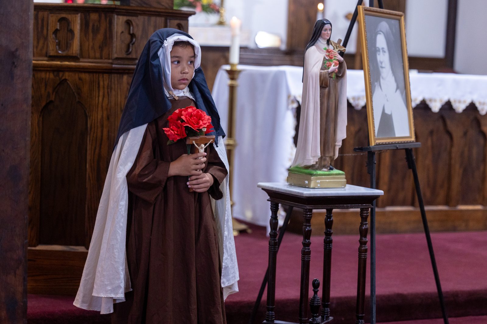 Charlotte Hartzer, a fourth grader at Little Flower School in Great Mills, Maryland, portrays St. Thérѐse of Lisieux during a Mass at Holy Face Church in Great Mills on Oct. 1, 2024 for the feast day of the school’s patron saint, who is known as the Little Flower. (Catholic Standard photo by Mihoko Owada)