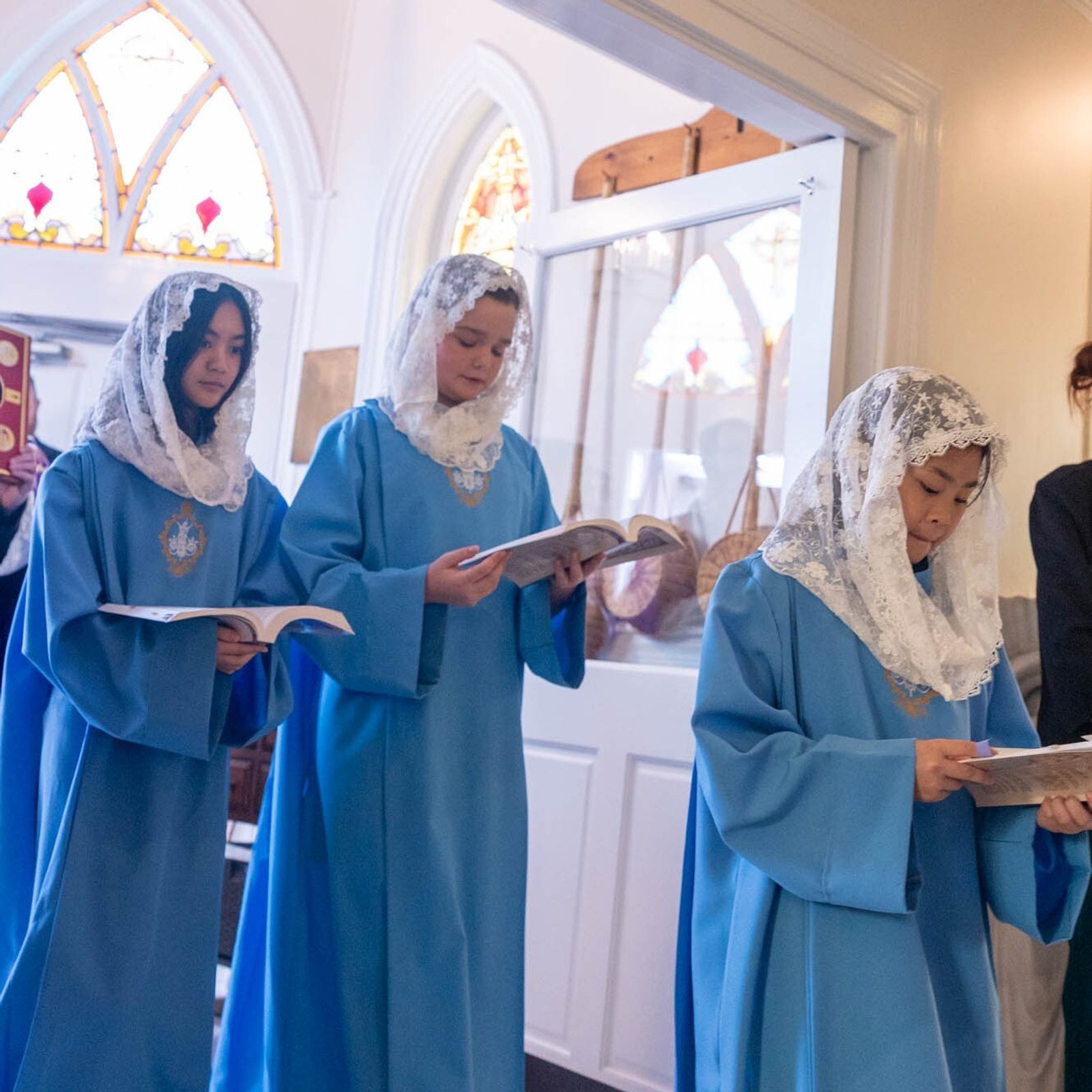 The opening procession for a Mass celebrated by Washington Cardinal Robert W. McElroy at St. John Francis Regis Church in Hollywood, Maryland, on March 8, 2026 included members of the parish’s Regina Guild, which is for girls open to considering religious life. (Catholic Standard photo by Mihoko Owada)