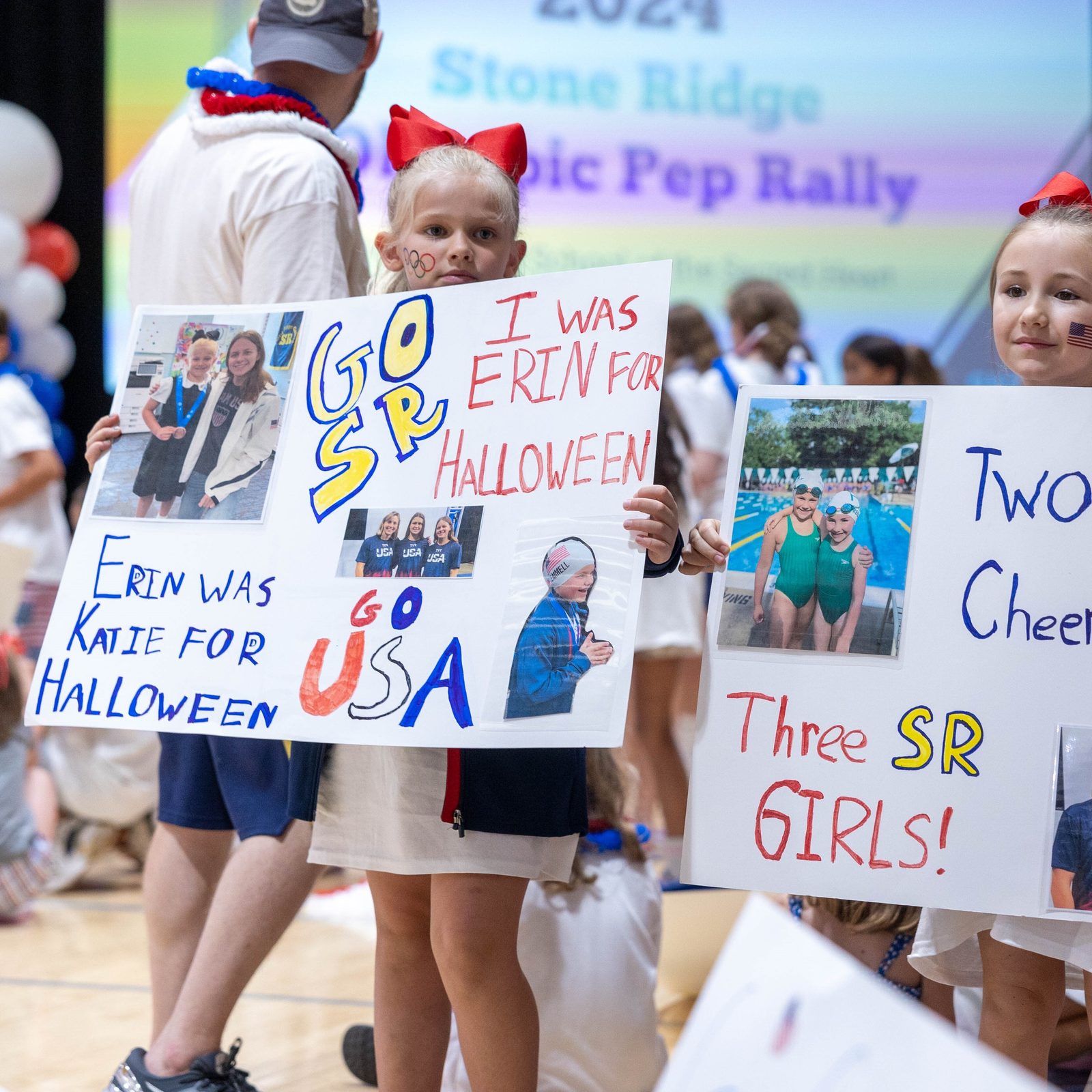 Two girls hold posters at a July 25 pep rally at Stone Ridge School of the Sacred Heart in Bethesda for three of the school’s graduates – Katie Ledecky (class of 2015), Phoebe Bacon (class of 2020) and Erin Gemmell (class of 2023) – who are members of the U.S. Olympic Swimming Team competing in the Summer Olympics in Paris. (Catholic Standard photo by Mihoko Owada)