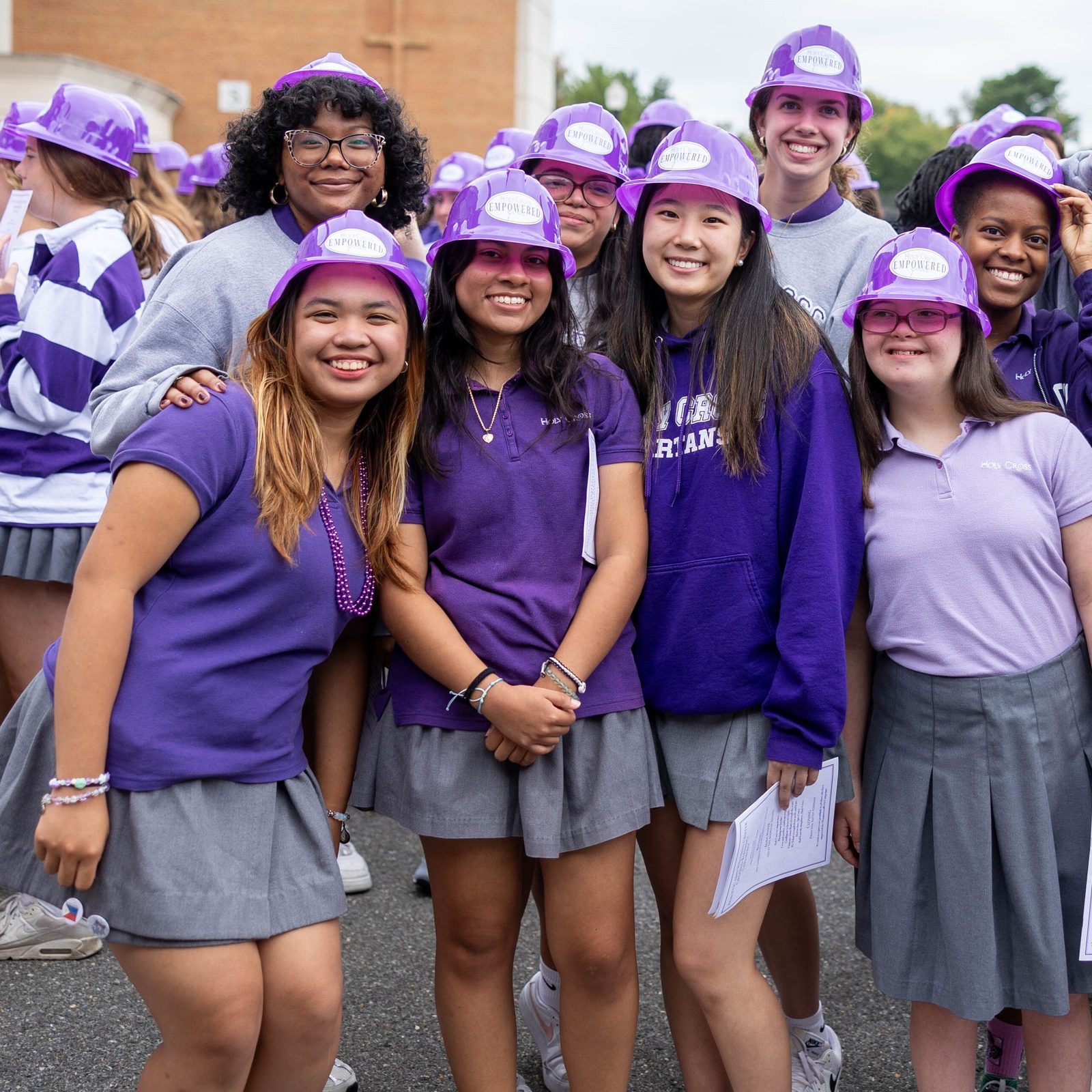 Students at The Academy of the Holy Cross in Kensington, Maryland, donned plastic purple hard hats for a ground blessing ceremony for the new Athletic and Wellness Center there on Sept. 13, 2024. Washington Cardinal Wilton Gregory said prayers and sprinkled holy water to bless the site where the new Athletic and Wellness Center will be built on the campus. (Catholic Standard photo by Mihoko Owada)