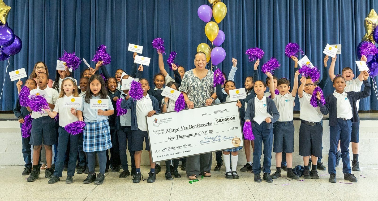 Margo VanDenBossche, a third grade teacher at Saint Peter’s School in Waldorf, Maryland, poses with her students after it was announced on April 15 that she is a 2024 Golden Apple Award winning teacher. Recipients of the Golden Apple Award receive a golden apple and a $5,000 monetary award for their excellence in teaching and dedication to Catholic education. (Catholic Standard photo by Mihoko Owada)