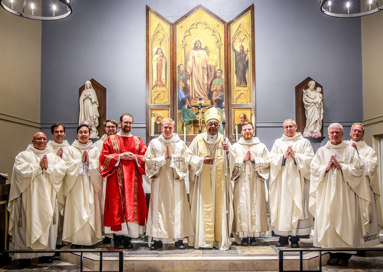 After Washington Cardinal Wilton Gregory celebrated a June 5, 2024 Mass at St. Mary’s Ryken High School in Leonardtown, Maryland and blessed the new altar at the school’s renovated Chapel of Charity, he then posed for a photo with the concelebrating priests and with the deacons who assisted at the Mass. From left to right are Father Scott Woods, Father Scott Holmer, Father Paul Nguyen, Father Ryan Braam, Deacon Ken Scheiber, Deacon Chris Feist, Cardinal Gregory, Deacon John Winslow, Father Gregory Coan, Father David Beaubien, and Father Raymond Schmidt. Father Braam, Deacon Feist and Deacon Winslow are graduates of St. Mary’s Ryken High School. (Photo by HD Photography for St. Mary’s Ryken High School)