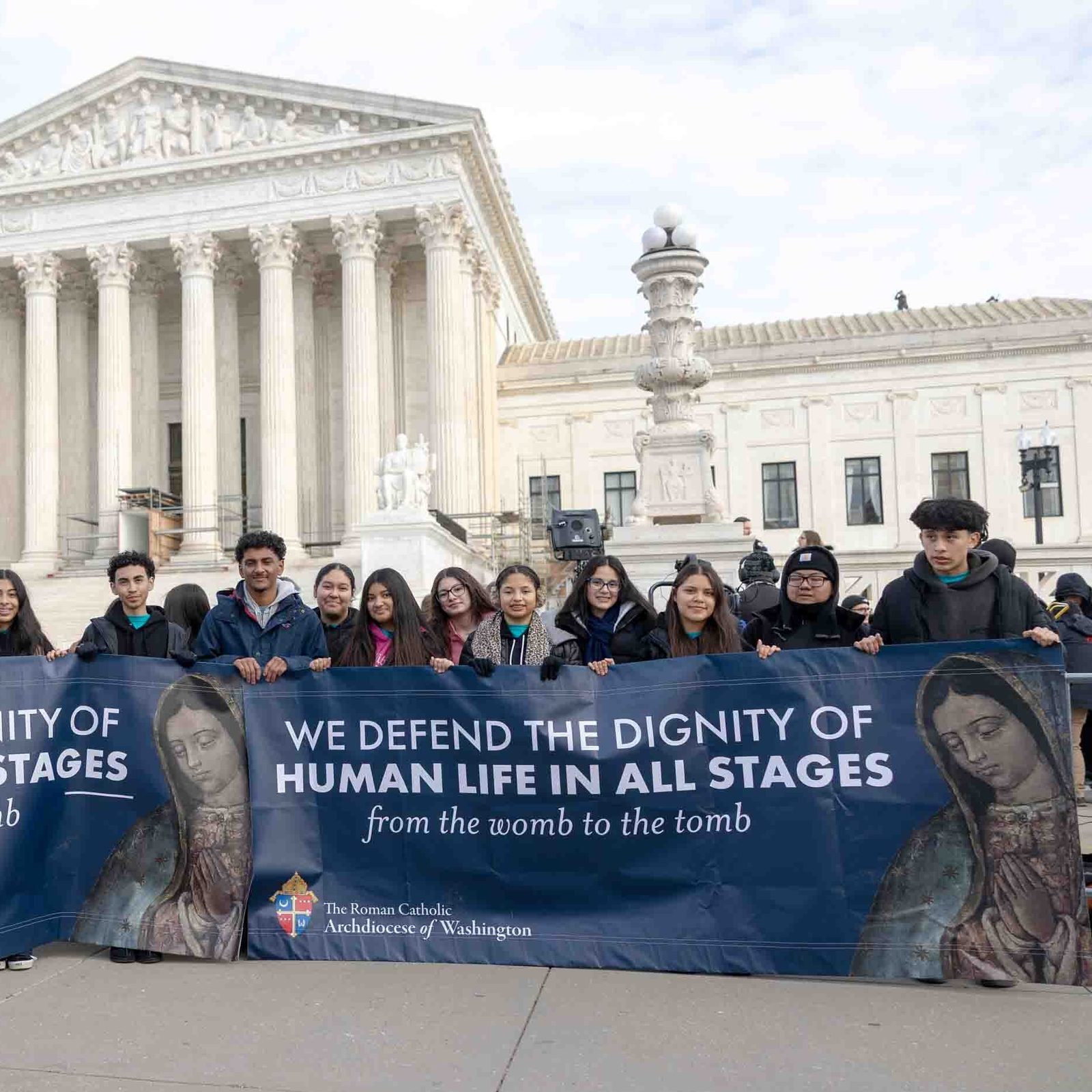 Standing near the U.S. Supreme Court, Washington Auxiliary Bishop Evelio Menjivar joins youth and young adults from the Roman Catholic Archdiocese of Washington who carried the archdiocese’s banners during the March for Life on Jan. 23, 2026. (Catholic Standard photo by Mihoko Owada)