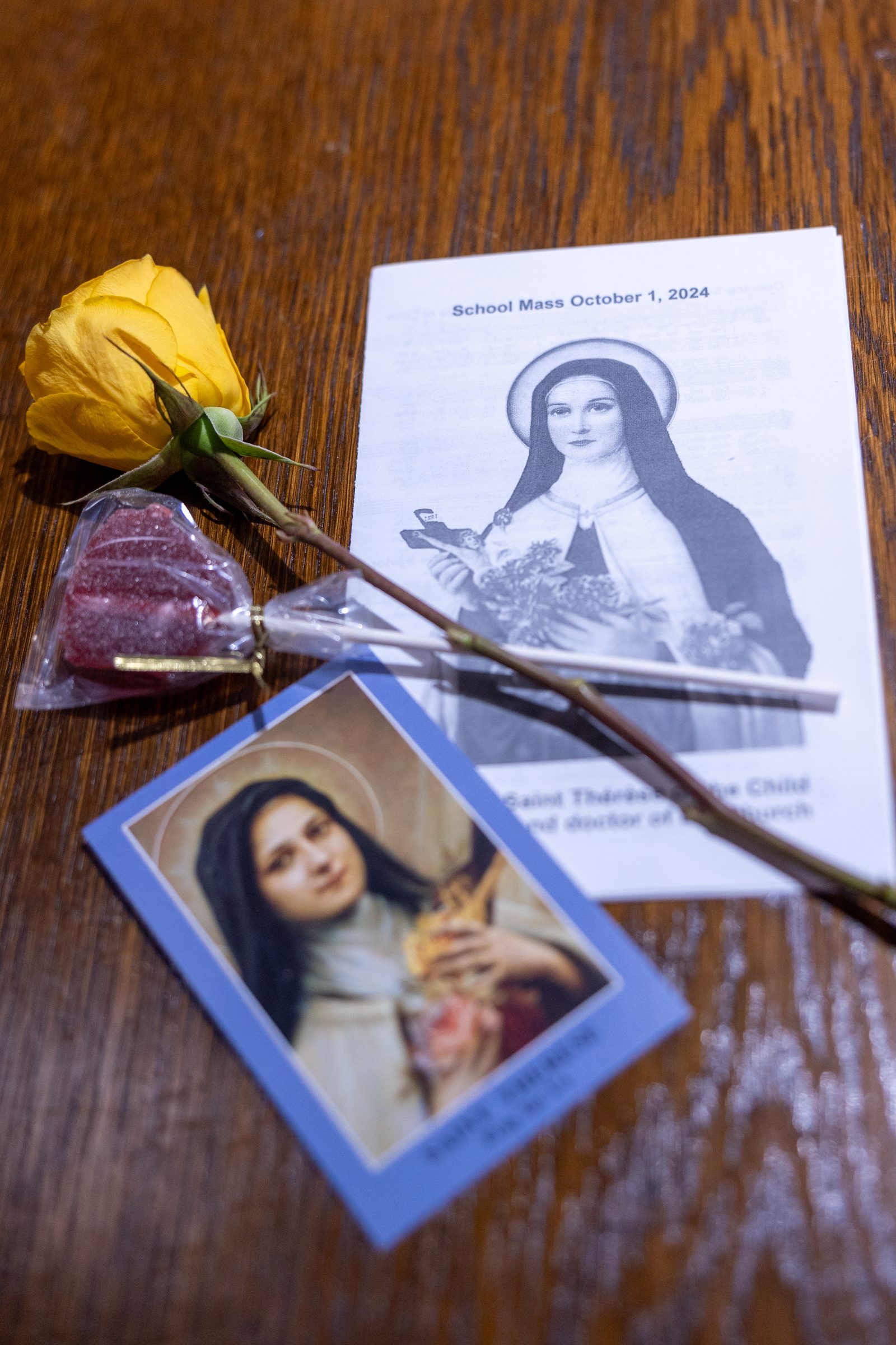 A Mass program and holy card bearing portraits of St. Thérѐse of Lisieux, along with roses, were given to special guests at Holy Face Church in Great Mills at a Mass for students from neighboring Little Flower School in Great Mills for the Oct. 1, 2024 feast day of their patron saint, who is known as the Little Flower. (Catholic Standard photo by Mihoko Owada)