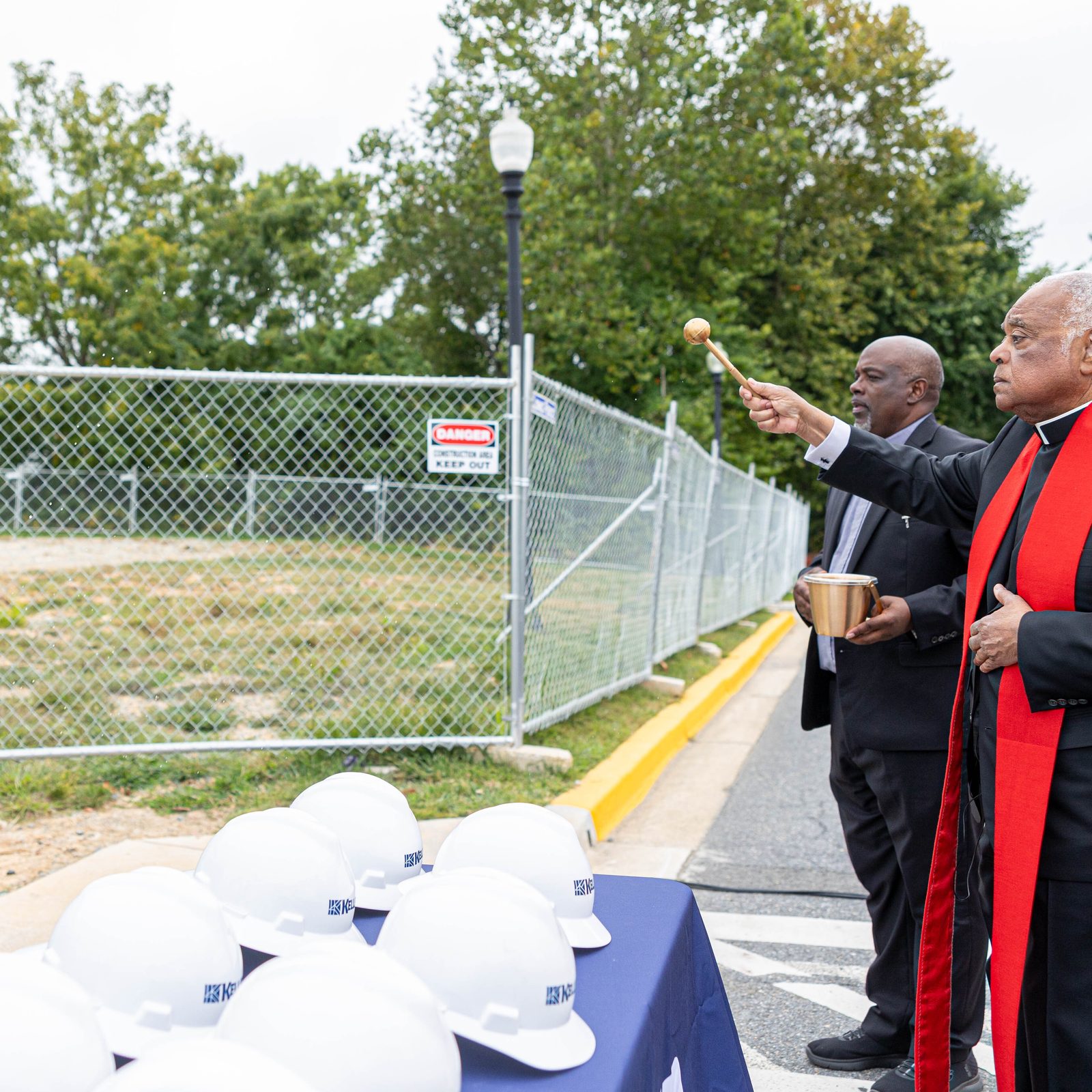 During a ground blessing ceremony on Sept. 13, 2024 at The Academy of the Holy Cross in Kensington, Washington Cardinal Wilton Gregory sprinkles holy water on the site of the new Athletic and Wellness Center that will be built there. (Catholic Standard photo by Mihoko Owada)