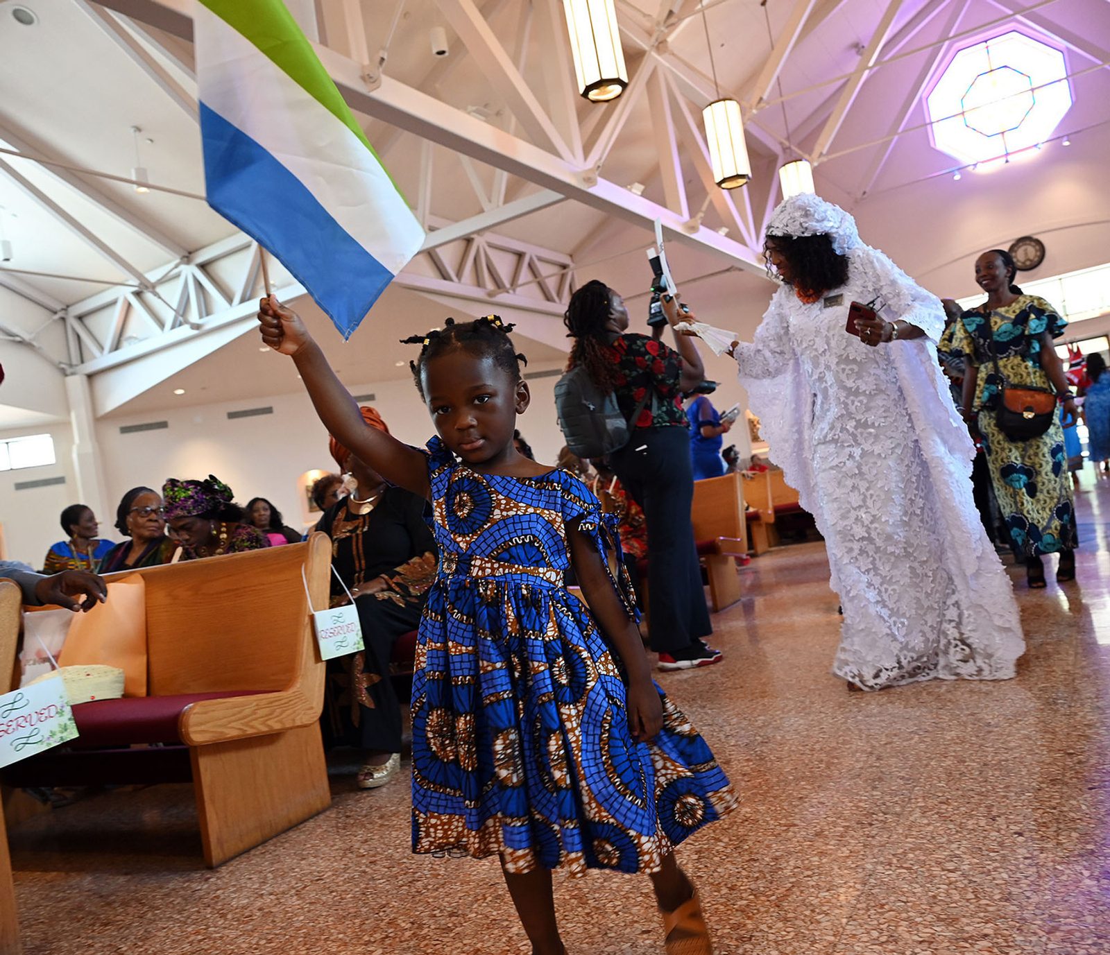 People carrying flags from different African nations process to the altar before the start of the ninth annual Africa Day Mass at Mother Seton Church in Germantown, Maryland on Aug. 20, 2023. (Catholic Standard photo by Leslie Kossoff)
