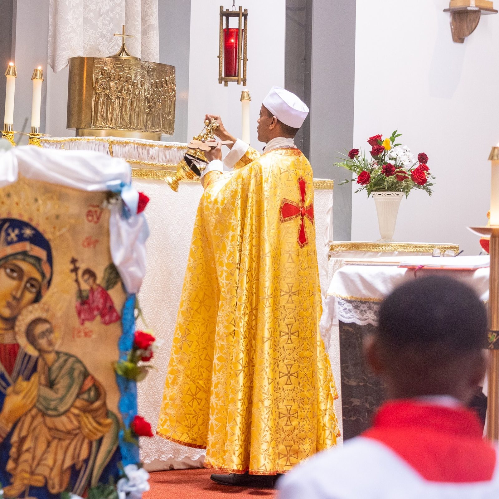 Father Abayneh Gebremichael, the pastor of Kidane-Mehret Parish for Ethiopian Catholics in the Archdiocese of Washington, incenses the altar at a Mass on Aug. 24, 2025 at Holy Spirit Church in Forestville, Maryland that marked the feast day of the Assumption of the Blessed Virgin Mary and also marked Holy Spirit Church being the new home for that community. (Catholic Standard photo by Mihoko Owada)