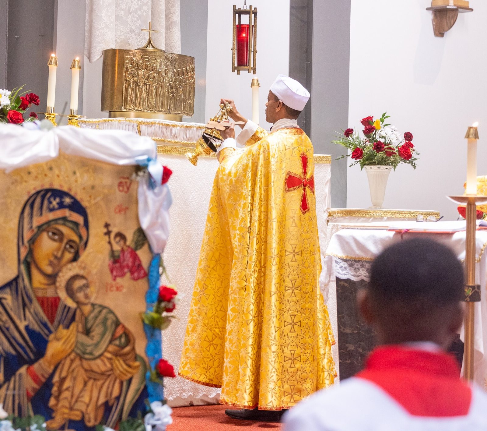Father Abayneh Gebremichael, the pastor of Kidane-Mehret Parish for Ethiopian Catholics in the Archdiocese of Washington, incenses the altar at a Mass on Aug. 24, 2025 at Holy Spirit Church in Forestville, Maryland that marked the feast day of the Assumption of the Blessed Virgin Mary and also marked Holy Spirit Church being the new home for that community. (Catholic Standard photo by Mihoko Owada)