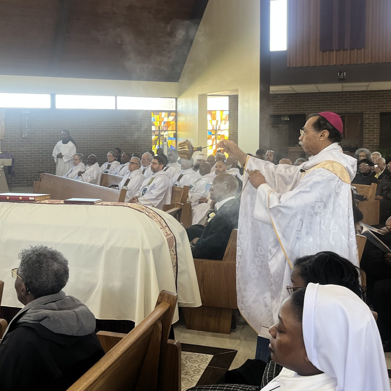 Washington Auxiliary Bishop Roy E. Campbell Jr. incenses the casket during the Funeral Mass for Josephite Father William L. Norvel Jr. on March 18, 2026 at Our Lady of Perpetual Help Church in Washington, D.C. (Catholic Standard photo by Mark Zimmermann)