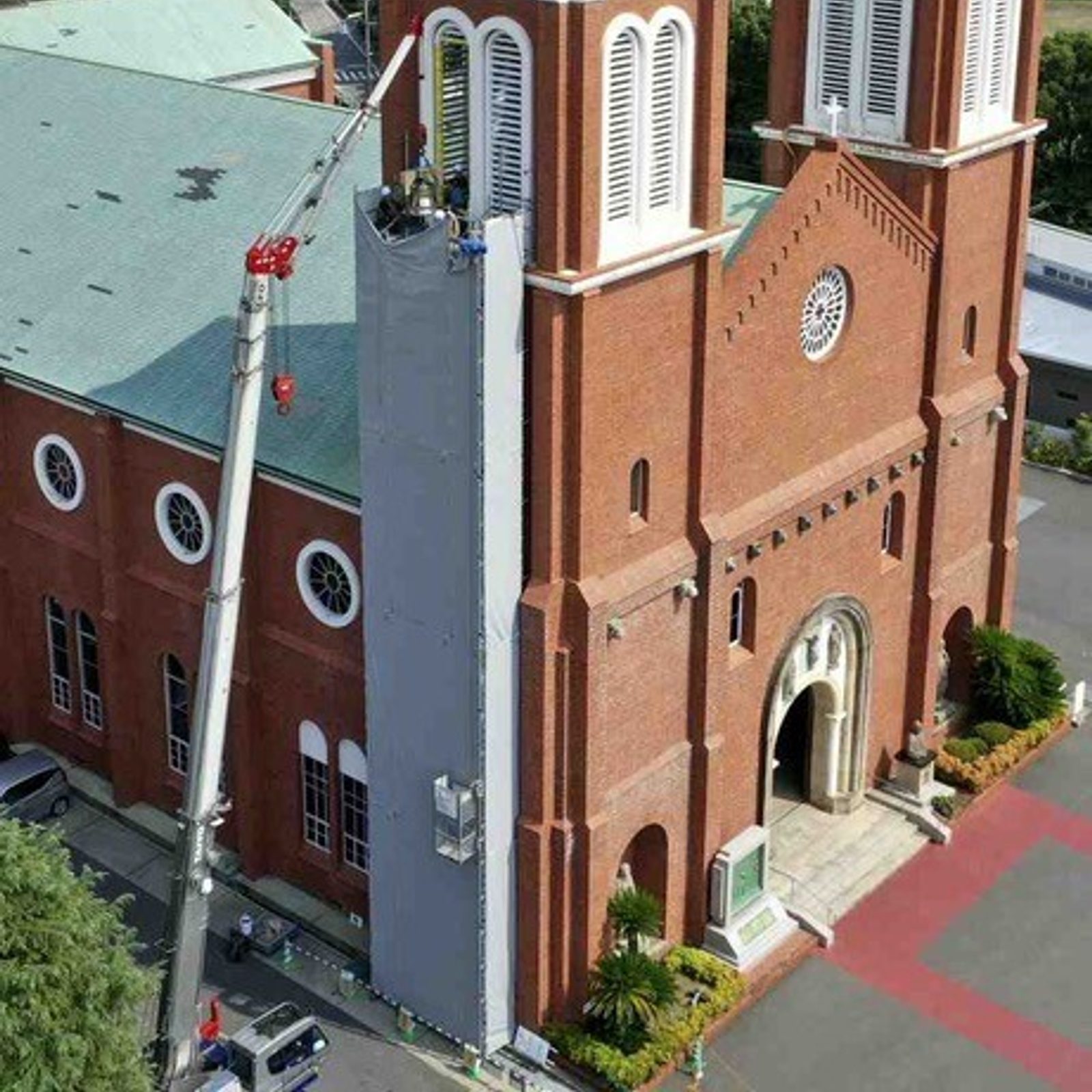 A new bell from U.S. Catholics is installed in a bell tower for Urakami Cathedral in Nagasaki, Japan in the summer of 2025. The bell rang out for peace with the bell in the adjacent bell tower on Aug. 9, 2025, commemorating the 80th anniversary of the U.S. atomic bombing of Nagasaki. Urakami Cathedral was destroyed when the atomic bomb exploded over Nagasaki. The cathedral was rebuilt in 1959, and one bell salvaged from the rubble was installed in one of the bell towers. Now with the new bell from U.S. Catholics, both towers have bells. (Photo courtesy of the Archdiocese of Nagasaki)