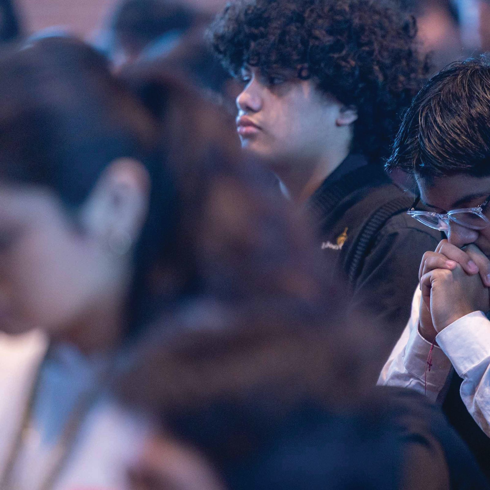 Rey Saavedra, a student at Don Bosco Cristo Rey High School in Takoma Park, prays during an Ash Wednesday Mass on Feb. 18 at Our Lady of Sorrows Church, which is next-door to the school. Student Fabian Mena is beside him. (Catholic Standard photo by Mihoko Owada)