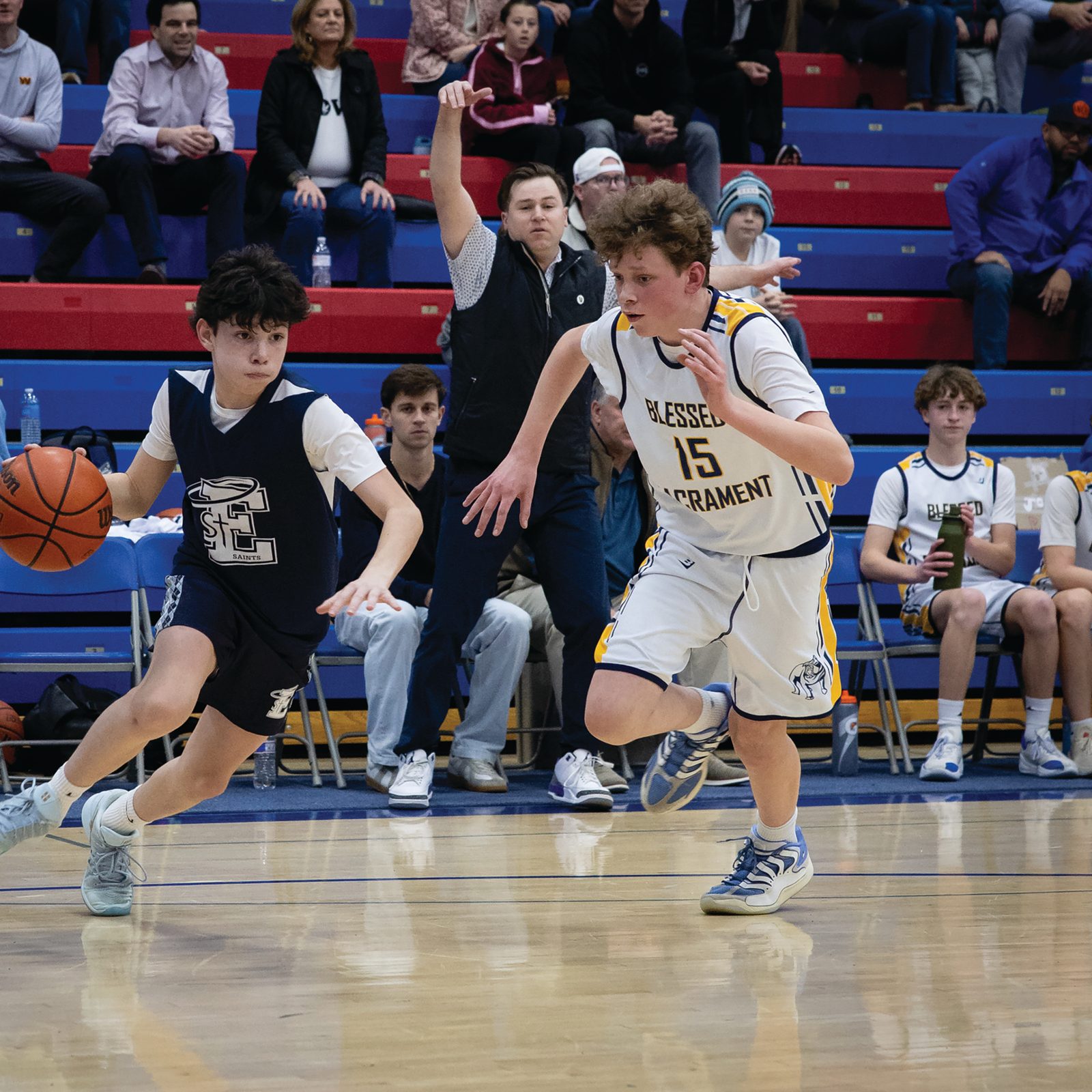 Blake Roberts from St. Elizabeth’s of Rockville drives down the court while being defended by John Robert MacMillan (#15) of Blessed Sacrament during the boys’ basketball CYO 14U championship game on Feb. 17 at DeMatha Catholic High School in Hyattsville. The team from Blessed Sacrament Parish in Washington defeated St. Elizabeth’s, 49-36. (Catholic Standard photo by Christopher Newkumet)