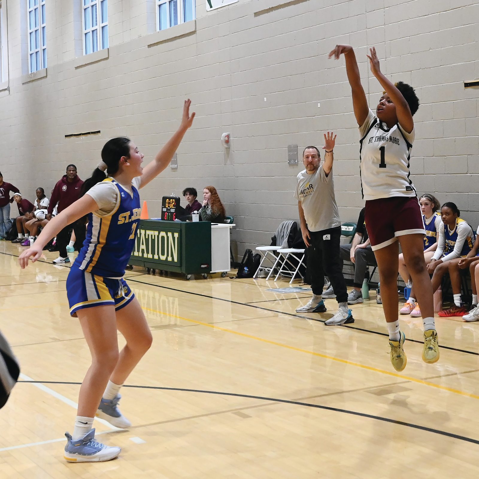 Ashley Hose  (#23) from St. Thomas More takes a shot while being defended by Mullyrana Durce (#33) of St. Jerome’s during the CYO girls’ 14U basketball championship game on Feb. 15 at Georgetown Visitation that was won by St. Thomas More, 34-26. (Catholic Standard photo by Patrick Ryan)