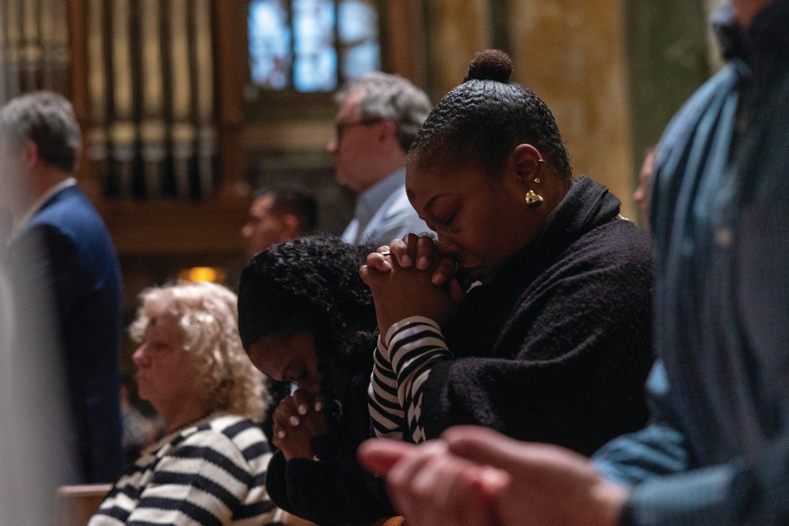 Above and below, the faithful pray during a March 5 Ash Wednesday Mass at the Cathedral of St. Matthew the Apostle. About 1,000 people attended the Mass, which was Cardinal Robert McElroy’s first public Mass in the Archdiocese of Washington since Pope Francis appointed him on Jan. 6 to replace the retiring archbishop of Washington, Cardinal Wilton Gregory. (Catholic Standard Photos by Mihoko Owada)