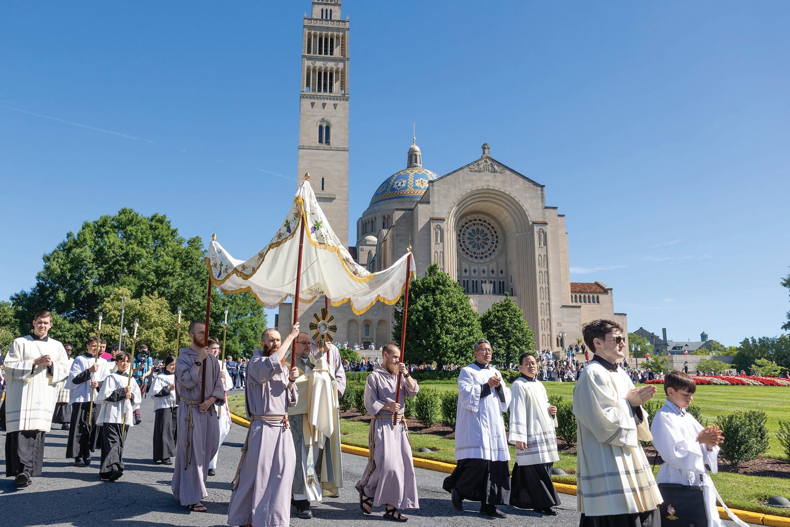 The faithful depart the Basilica of the National Shrine of the Immaculate Conception June 8 as they follow the Blessed Sacrament in procession through the streets of the Brookland neighborhood of Washington, D.C. The procession was held as the National Eucharistic Pilgrimage stopped in The Roman Catholic Archdiocese of Washington as it made its way to the National Eucharistic Congress in Indianapolis. (CS photo by Mihoko Owada)