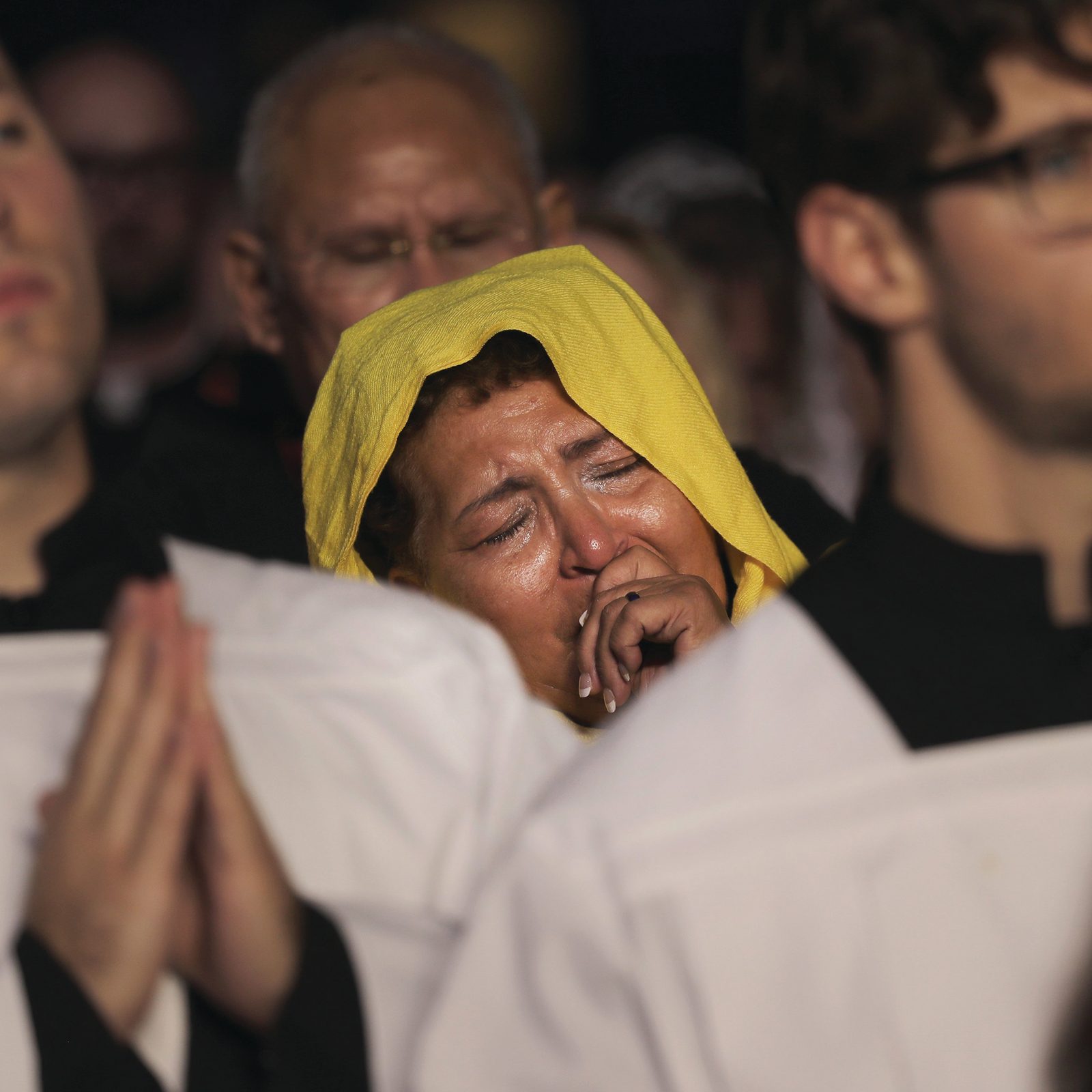 Above and below, pilgrims pray during Eucharistic adoration at the opening revival night July 17, 2024, of the National Eucharistic Congress at Lucas Oil Stadium in Indianapolis. (OSV News photo/Bob Roller)