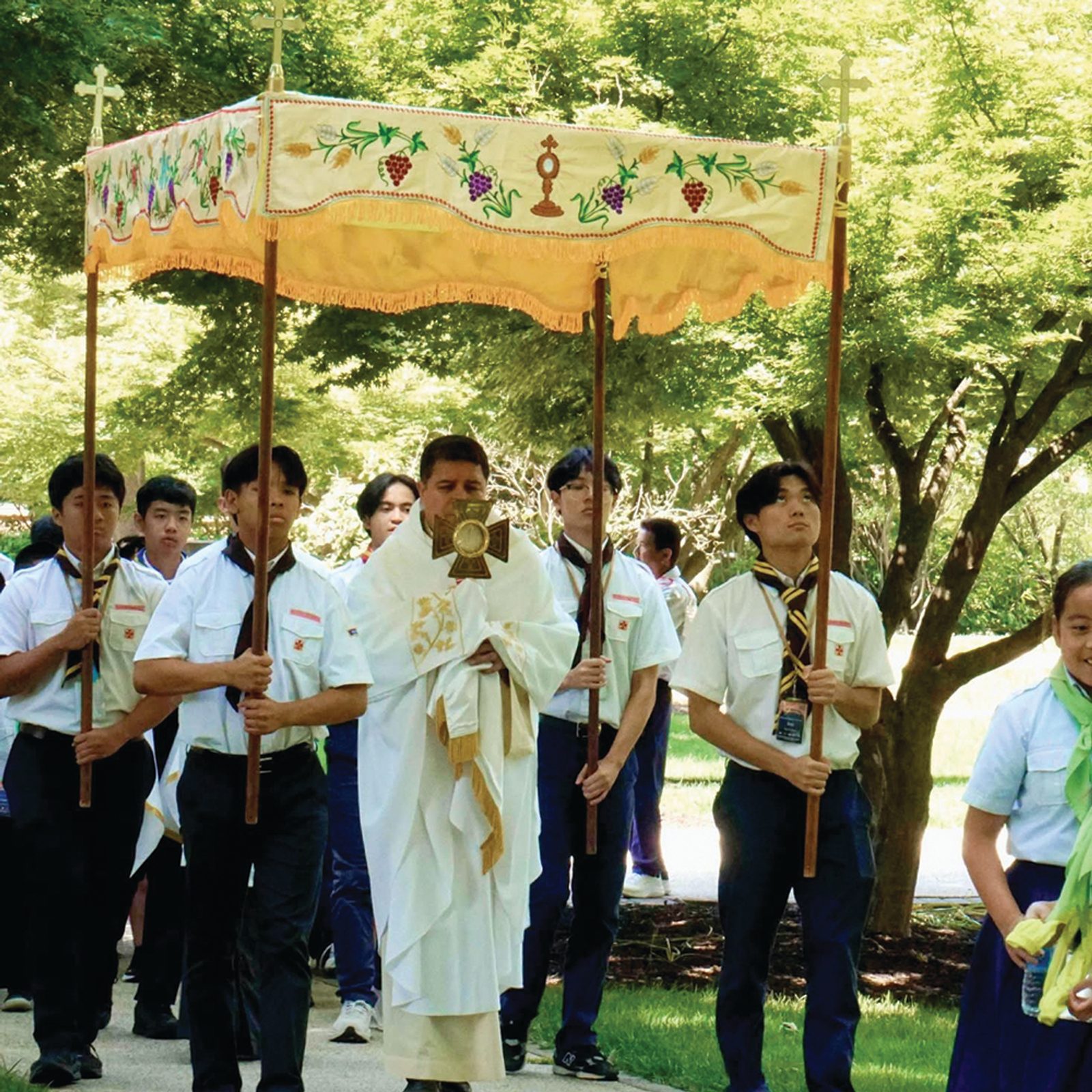 Participants in the Vietnamese Eucharistic Youth Movement retreat join a Eucharistic procession led by Washington Auxiliary Bishop Evelio Menjivar on the grounds of Georgetown Preparatory School. The three-day retreat encouraged youth to live as “missionary disciples” and concluded on the Solemnity of Corpus Christi. (Photo courtesy of VEYM-USA)