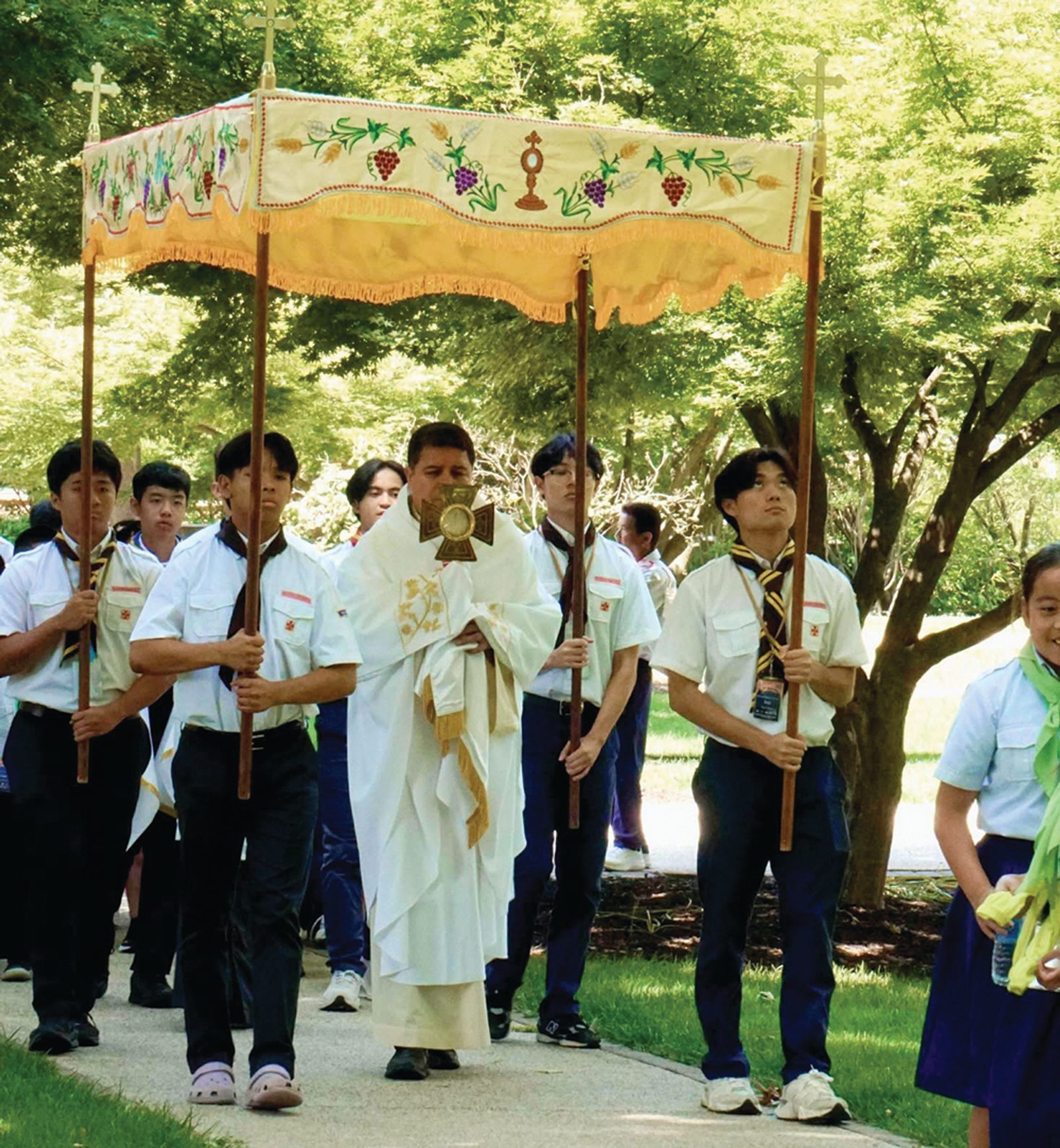 Participants in the Vietnamese Eucharistic Youth Movement retreat join a Eucharistic procession led by Washington Auxiliary Bishop Evelio Menjivar on the grounds of Georgetown Preparatory School. The three-day retreat encouraged youth to live as “missionary disciples” and concluded on the Solemnity of Corpus Christi. (Photo courtesy of VEYM-USA)