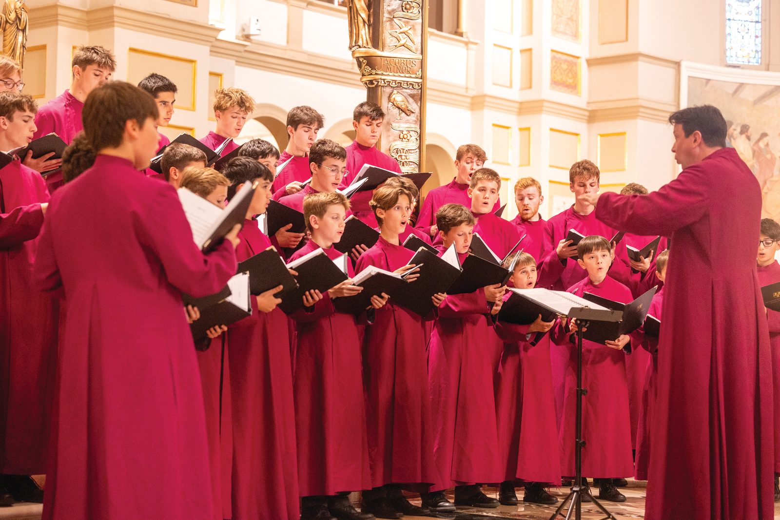Above and below, Charles Cole directs the Schola Cantorum of the London Oratory School in the concert of “Sacred Treasures of England, Spain, and Italy,” that featured motets by Giovanni Pierluigi Da Palestrina, Giovanni Gabriel, John Shepherd and other renowned Renaissance composers. (Catholic Standard photos by Mihoko Owada)