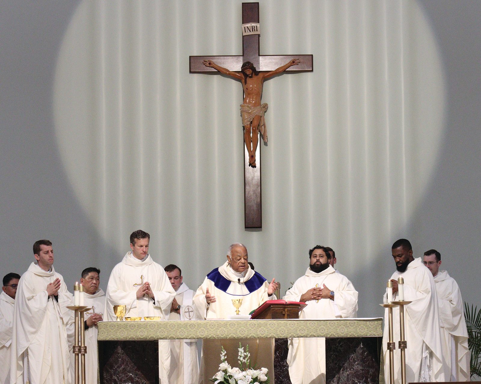 Washington Cardinal Wilton Gregory, at center, was the main celebrant of a Seminarian Family Day Mass on July 27, 2024 at St. Mary’s Church in Landover Hills. The Mass and a luncheon afterward were sponsored by The Roman Catholic Archdiocese of Washington. Standing at the altar from left to right are Father Brendan Glasgow, a formation advisor at the archdiocese’s Saint John Paul II Seminary in Washington; Father Mark Ivany, the archdiocese’s director of priest vocations; Cardinal Gregory; Father Mario Majano, St. Mary’s pastor; and Father Ebuka Mbanude, the archdiocesan director of the Office of Evangelization and Pastoral Planning. (Catholic Standard photo by Javier Diaz)