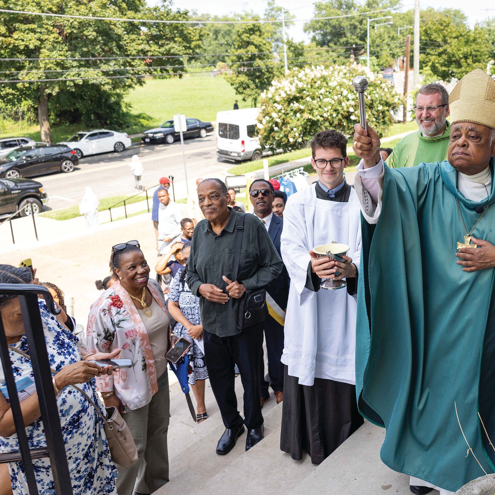 Above and below, Cardinal Wilton Gregory, the archbishop emeritus of the Roman Catholic Archdiocese of Washington blesses the new elevator at Nativity Church on Georgia Avenue, N.W. Behind him is Father Pawel Sass, pastor of the parish. (CS photos by Andrew Biraj)