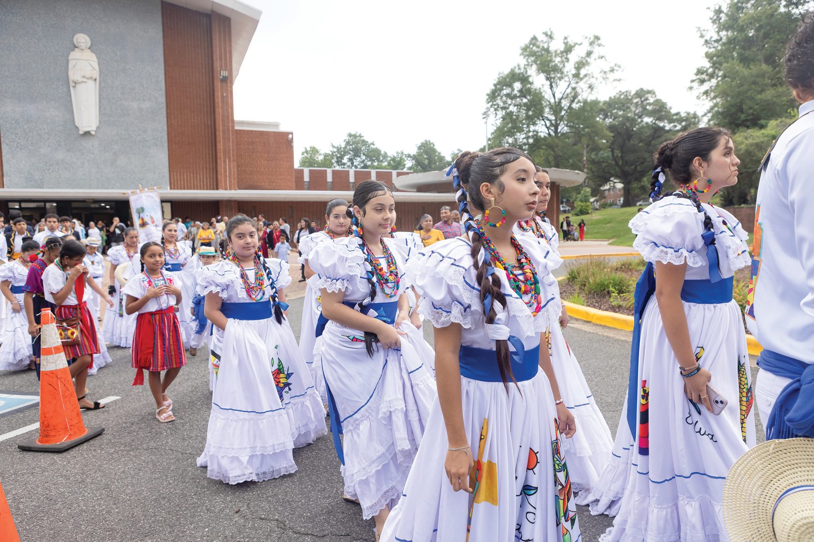 Young members of St. Bernard of Clairvaux Parish in Riverdale Park, Maryland, participate in a procession from the church after Cardinal Wilton Gregory celebrated an Aug. 17 Mass to mark the 75th anniversary Mass of the parish. (Catholic Standard photo by Rachel Lincoln)